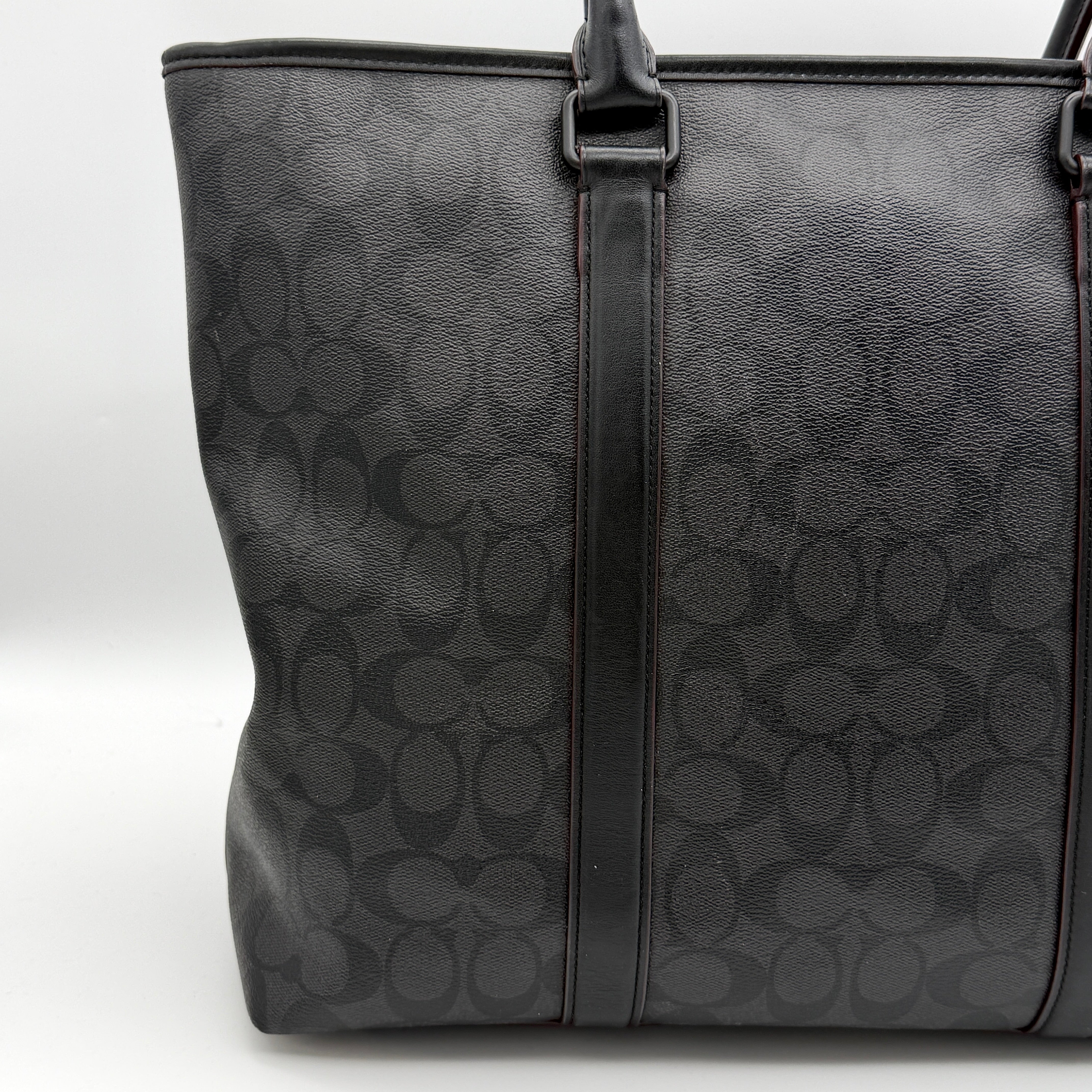 Coach Perry Business Tote in charcoal black signature canvas with double handles and detachable strap, shown upright against a white background.