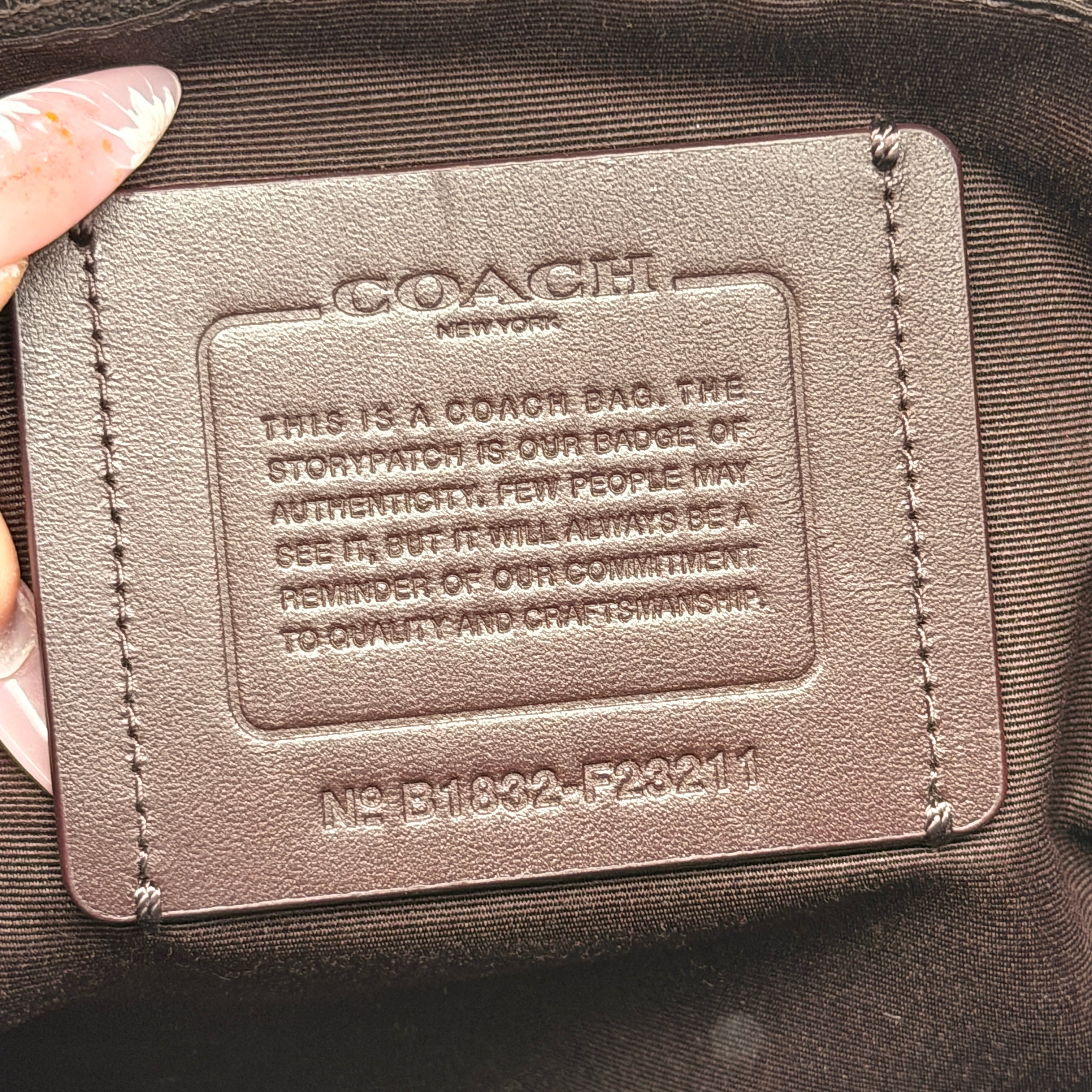 Coach Perry Business Tote in charcoal black signature canvas with double handles and detachable strap, shown upright against a white background.