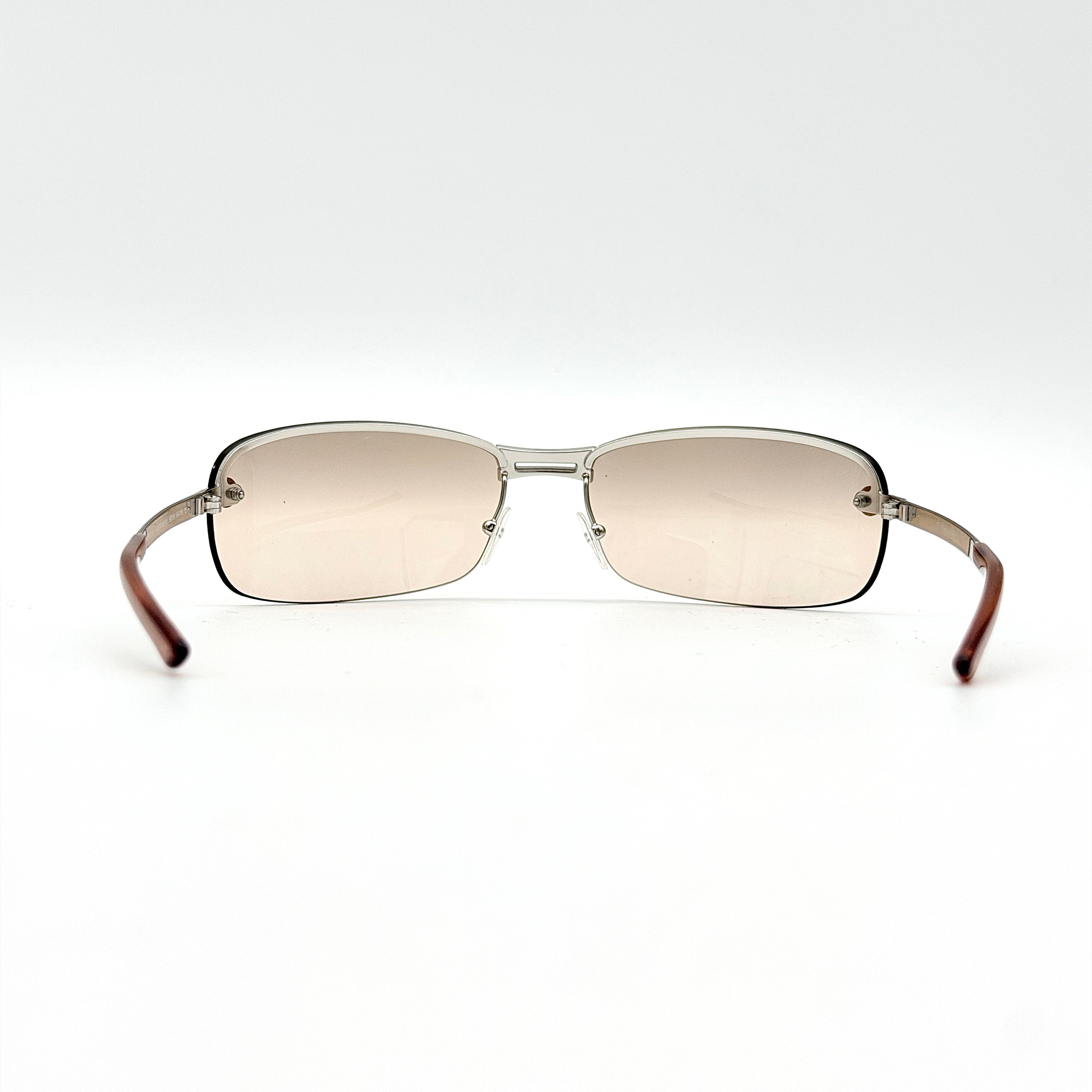 Dior Adiorable 3/L sunglasses in silver with brown gradient lenses, displayed in front of the Dior hard case.