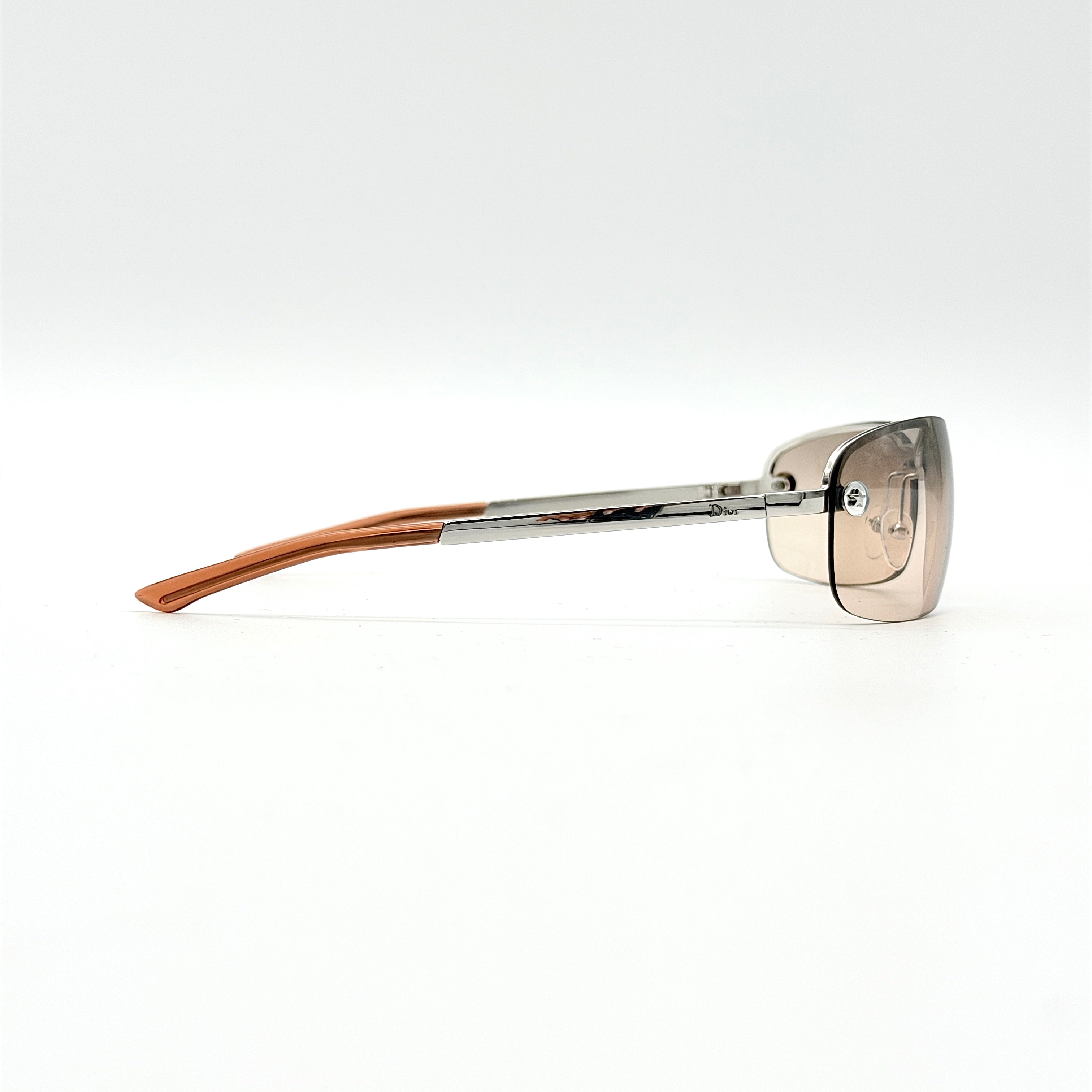 Dior Adiorable 3/L sunglasses in silver with brown gradient lenses, displayed in front of the Dior hard case.
