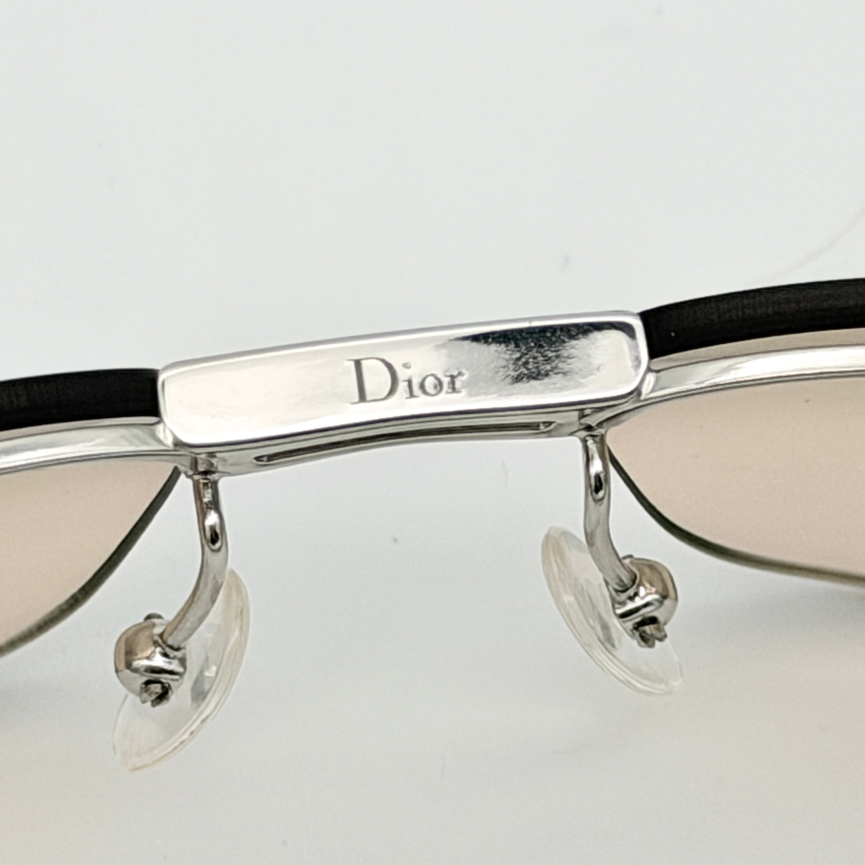Dior Adiorable 3/L sunglasses in silver with brown gradient lenses, displayed in front of the Dior hard case.