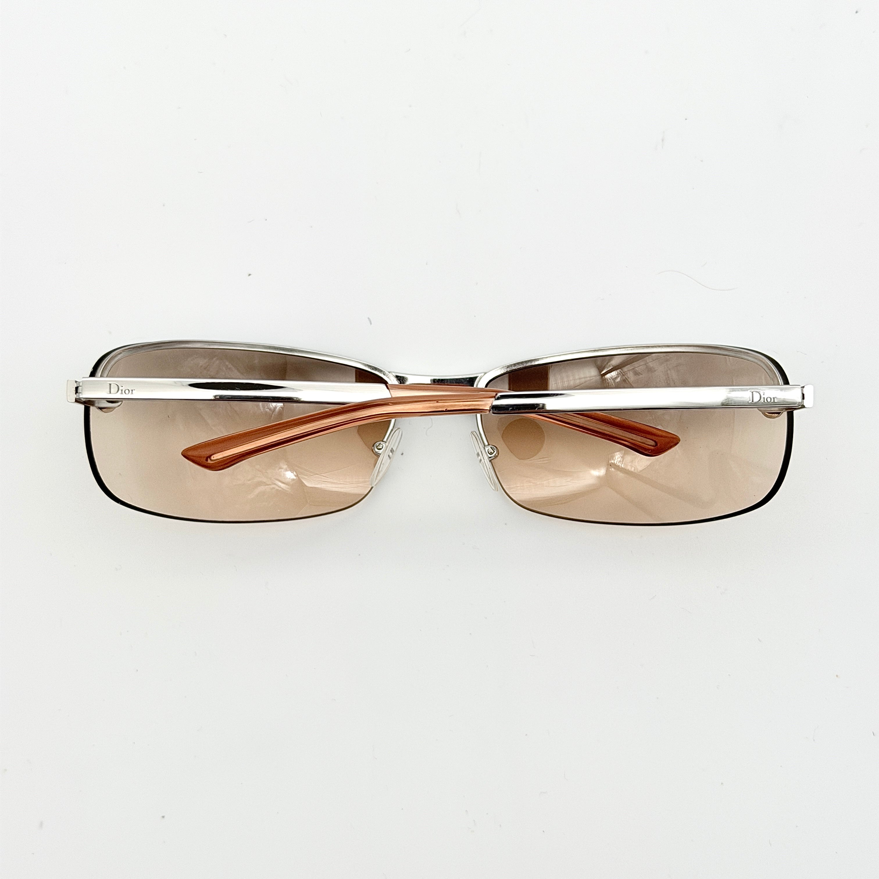 Dior Adiorable 3/L sunglasses in silver with brown gradient lenses, displayed in front of the Dior hard case.