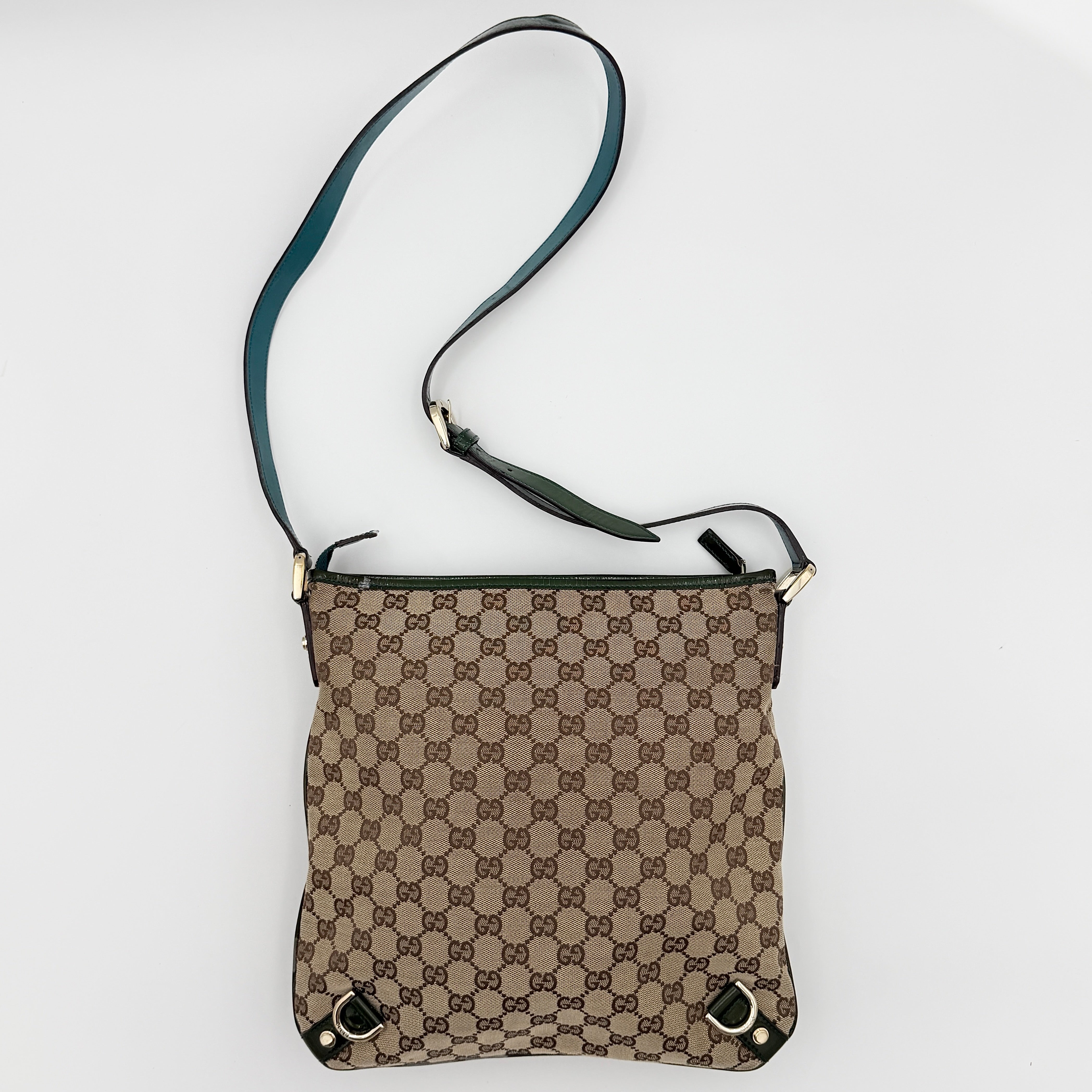 Gucci GG Monogram Abbey D Ring Crossbody Bag in beige canvas with green leather trim and gold-tone hardware, featuring an adjustable green strap.