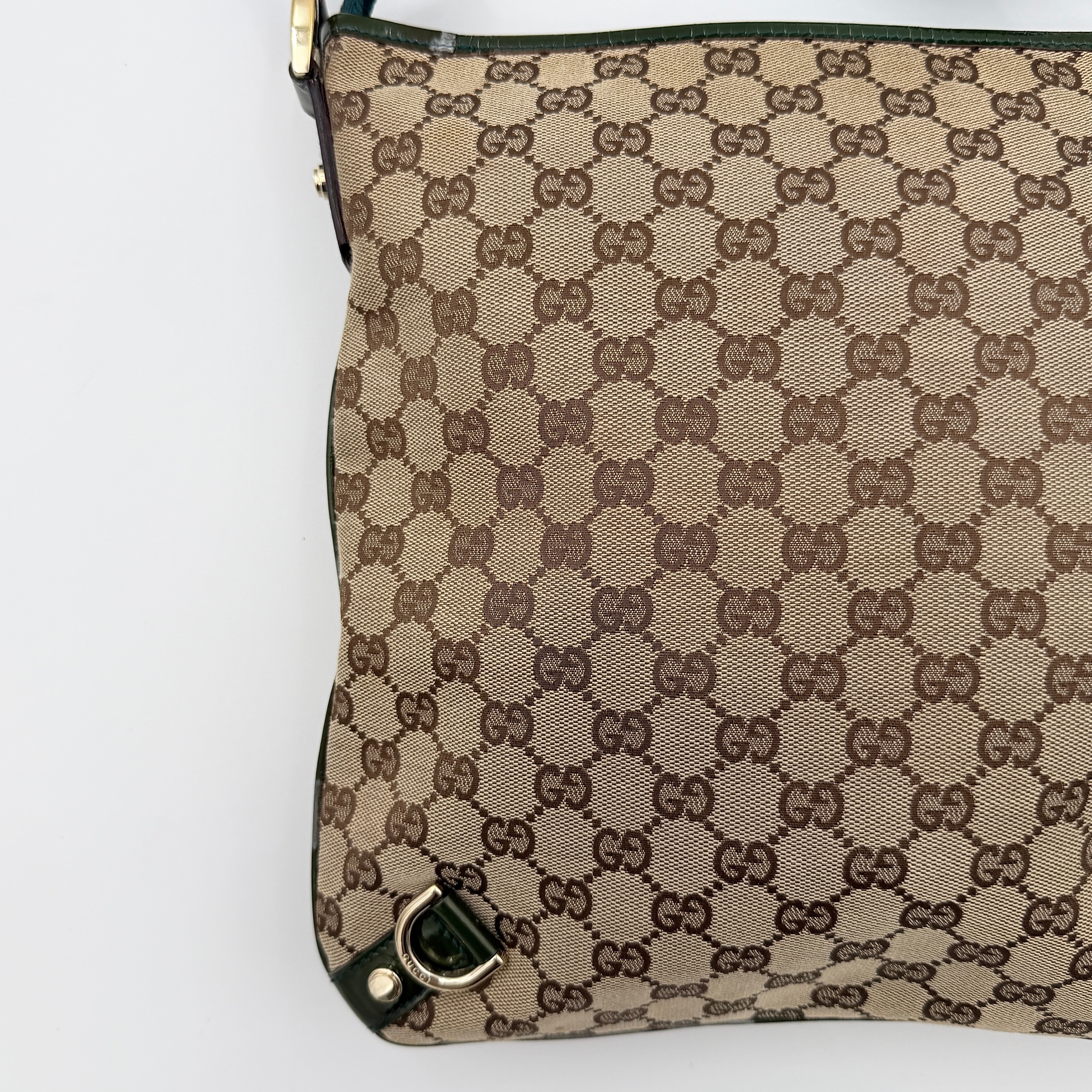 Gucci GG Monogram Abbey D Ring Crossbody Bag in beige canvas with green leather trim and gold-tone hardware, featuring an adjustable green strap.