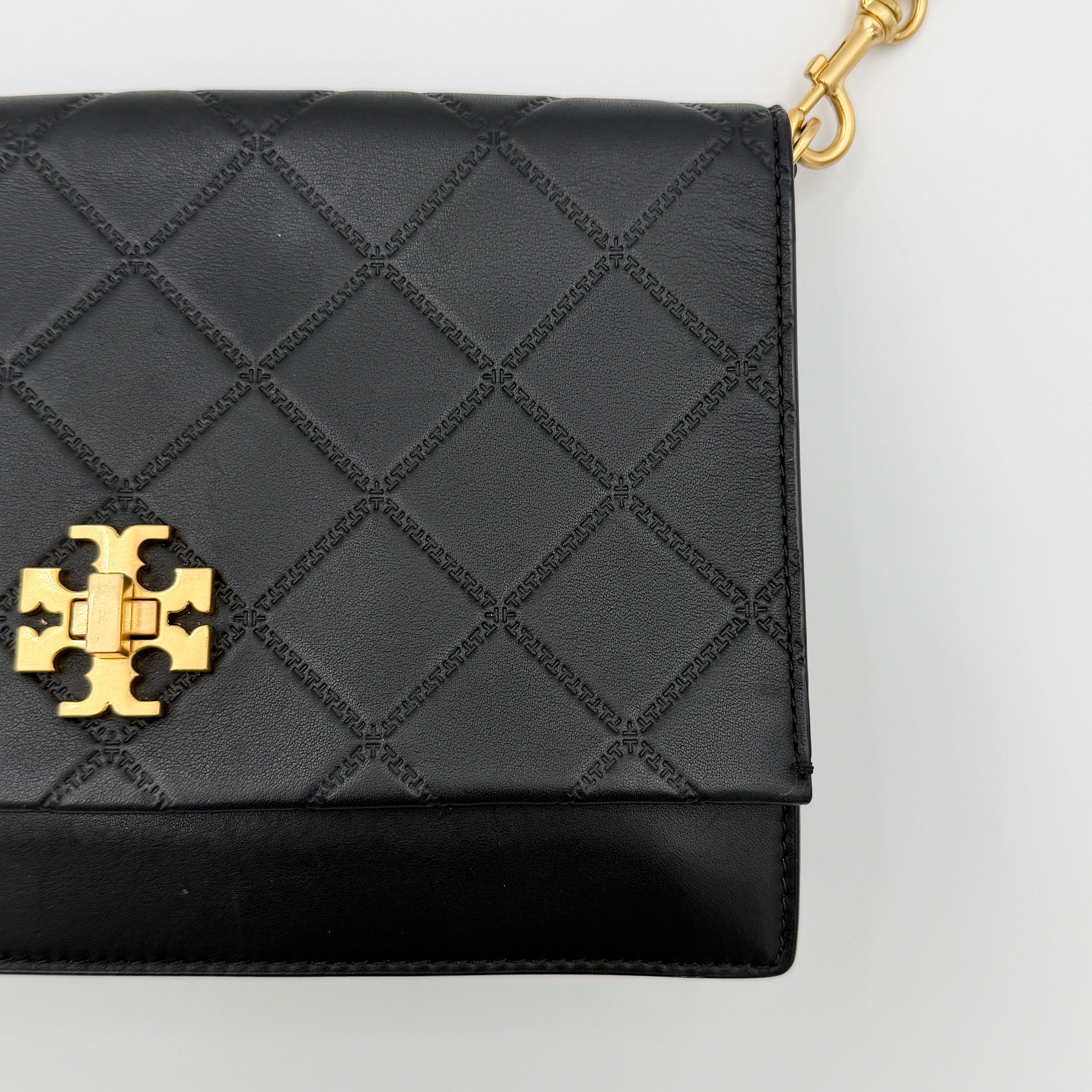 Tory Burch Georgia crossbody in black quilted leather with gold hardware, styled with adjustable chain and leather strap.