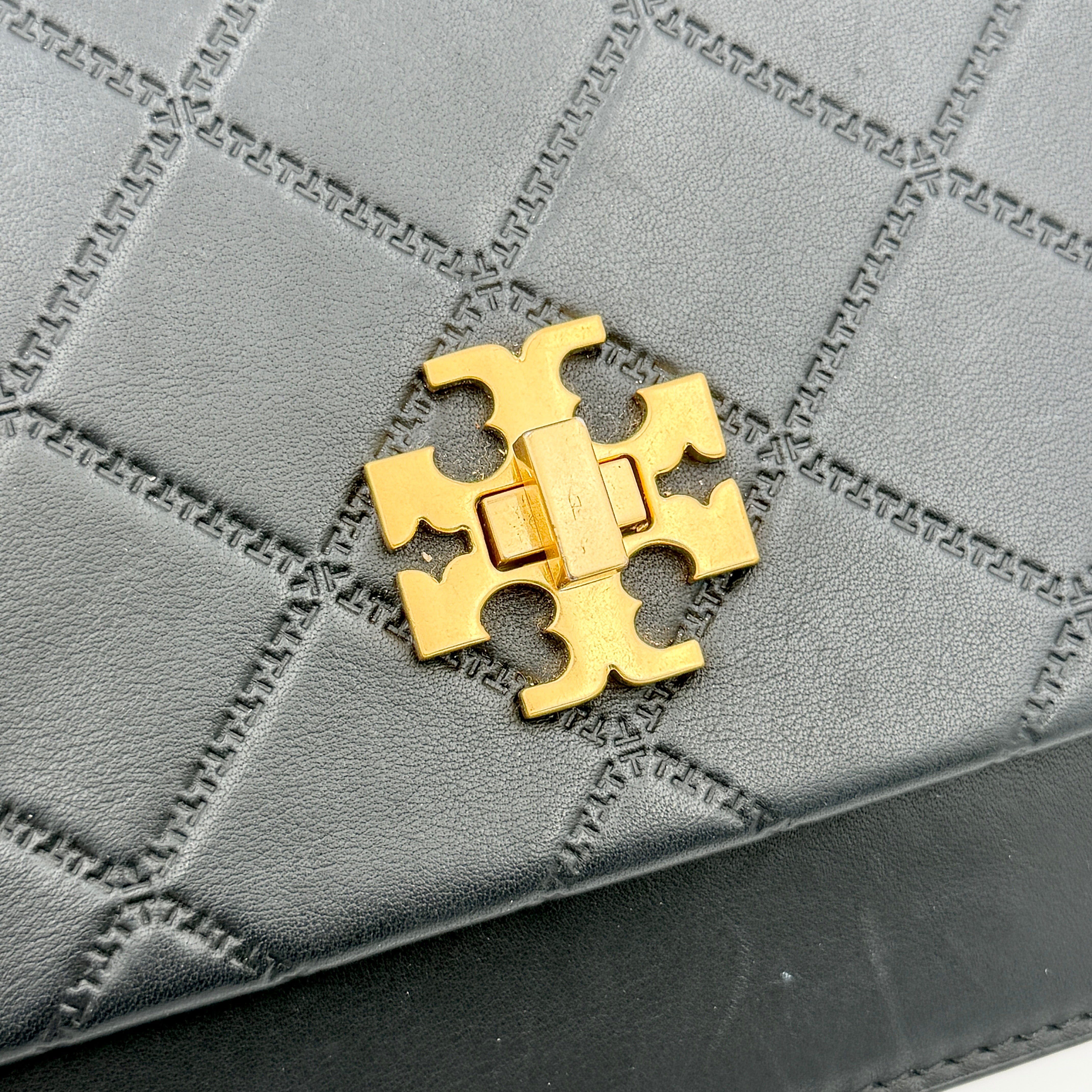 Tory Burch Georgia crossbody in black quilted leather with gold hardware, styled with adjustable chain and leather strap.