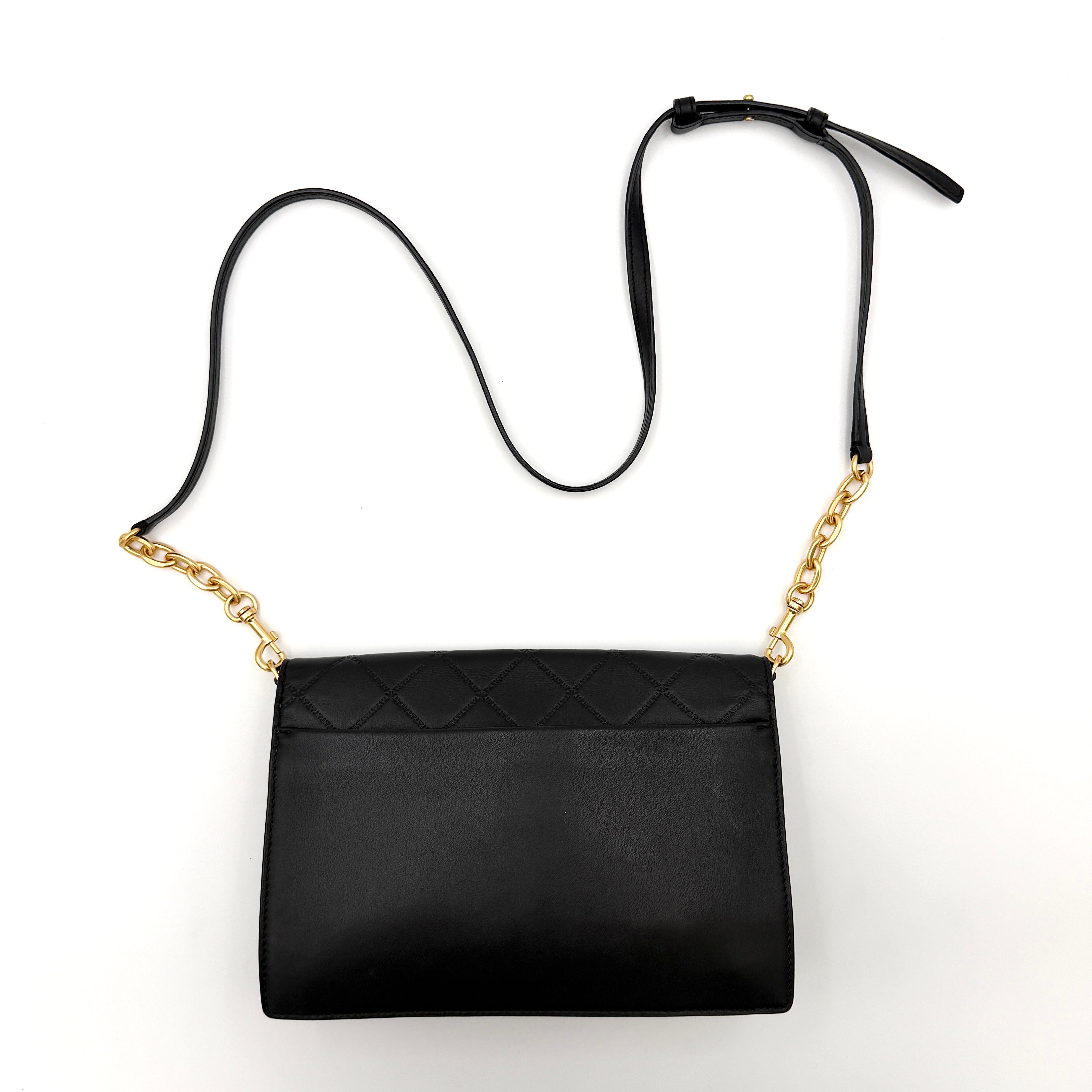 Tory Burch Georgia crossbody in black quilted leather with gold hardware, styled with adjustable chain and leather strap.