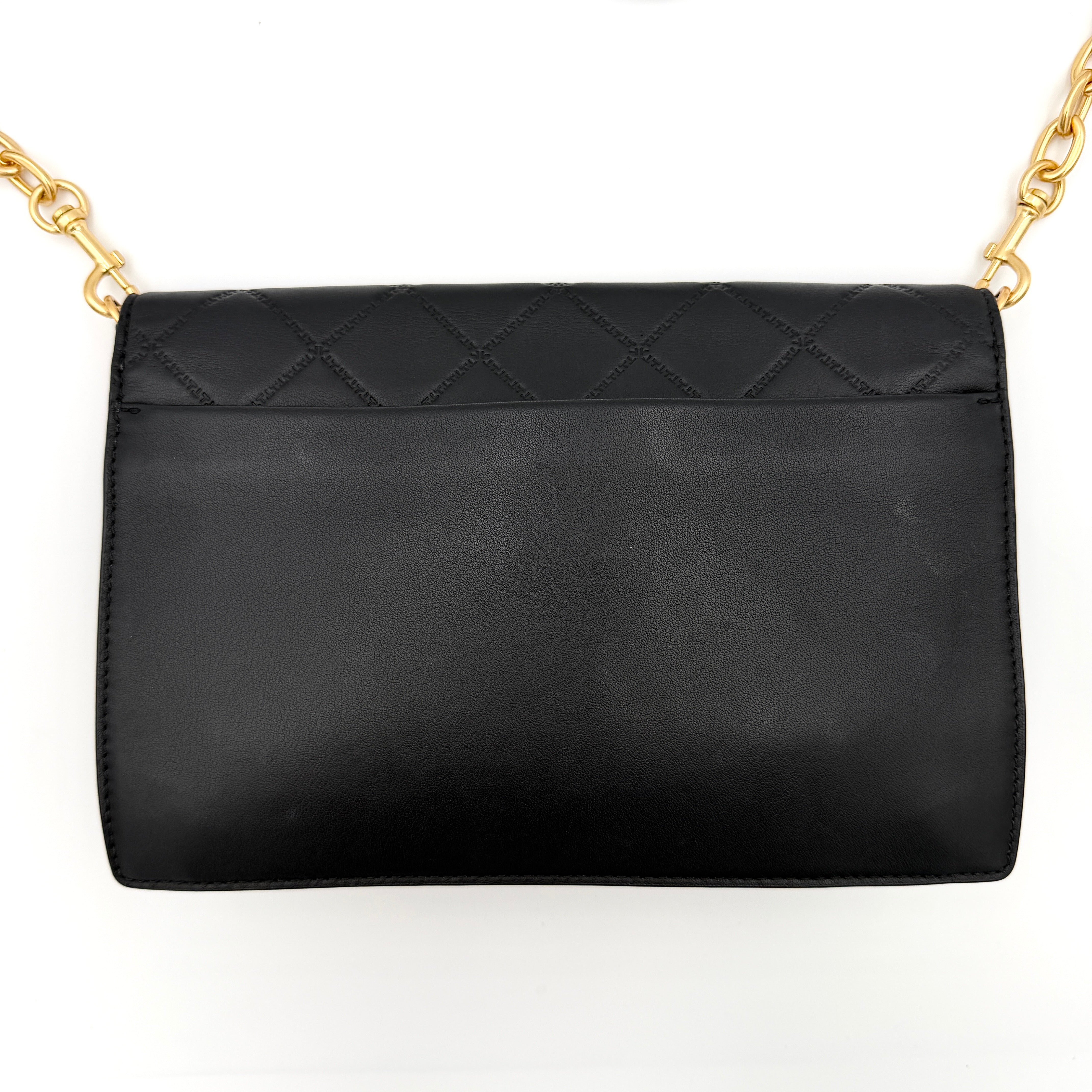 Tory Burch Georgia crossbody in black quilted leather with gold hardware, styled with adjustable chain and leather strap.
