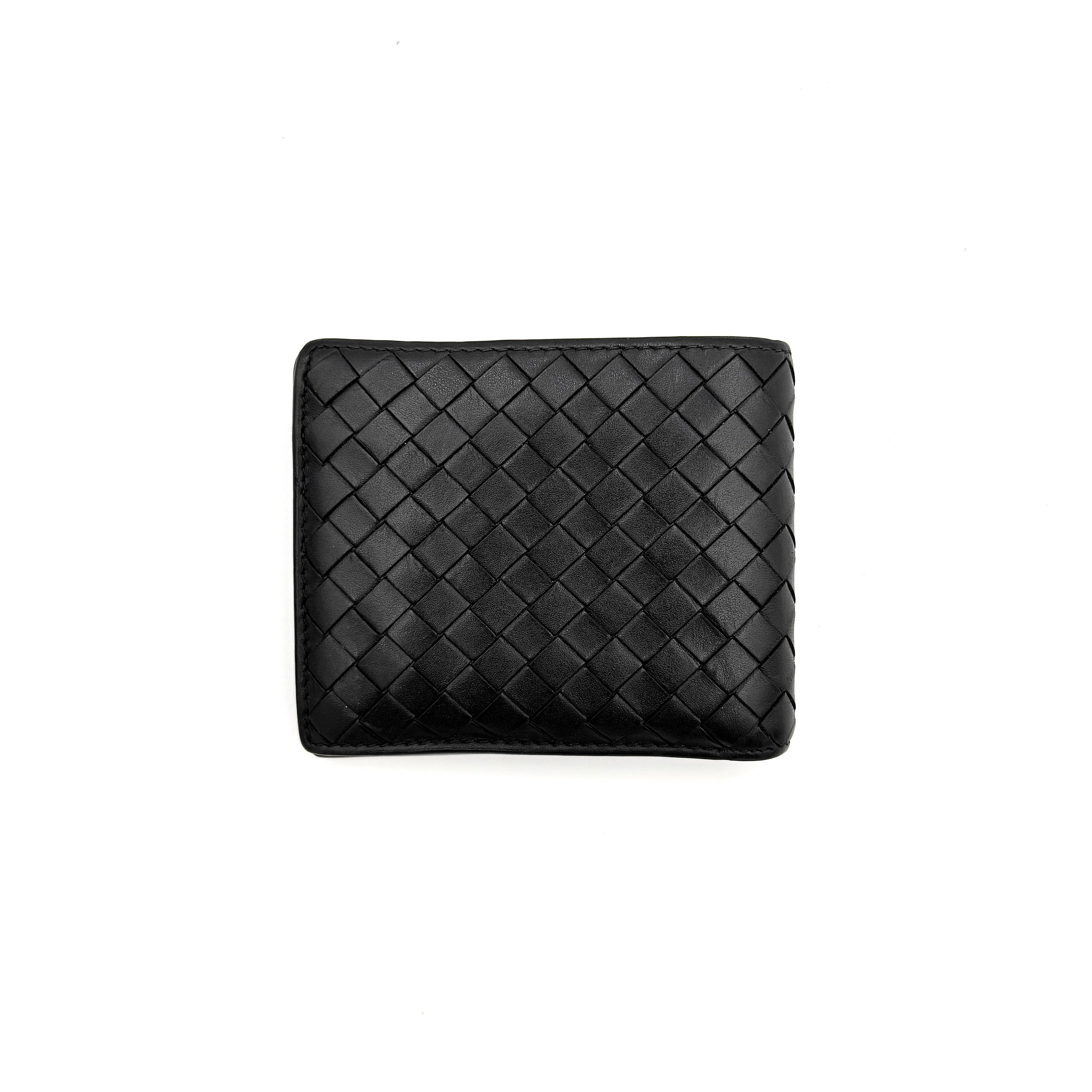 Bottega Veneta black intrecciato leather wallet shown against a plain background highlighting its woven texture.