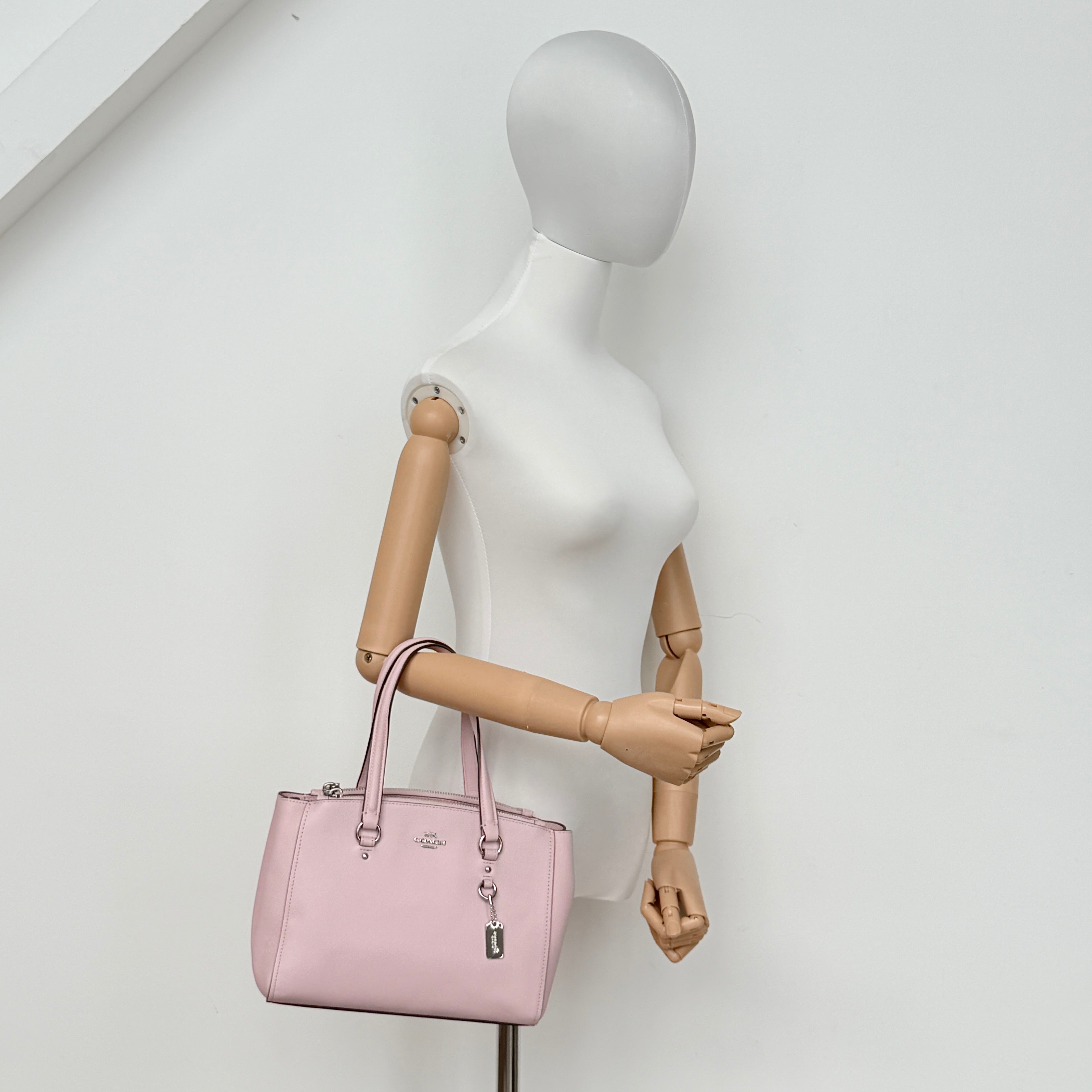 Coach Stanton 26 Carryall in blush pink grained leather with dual handles, silver hardware, and detachable strap.