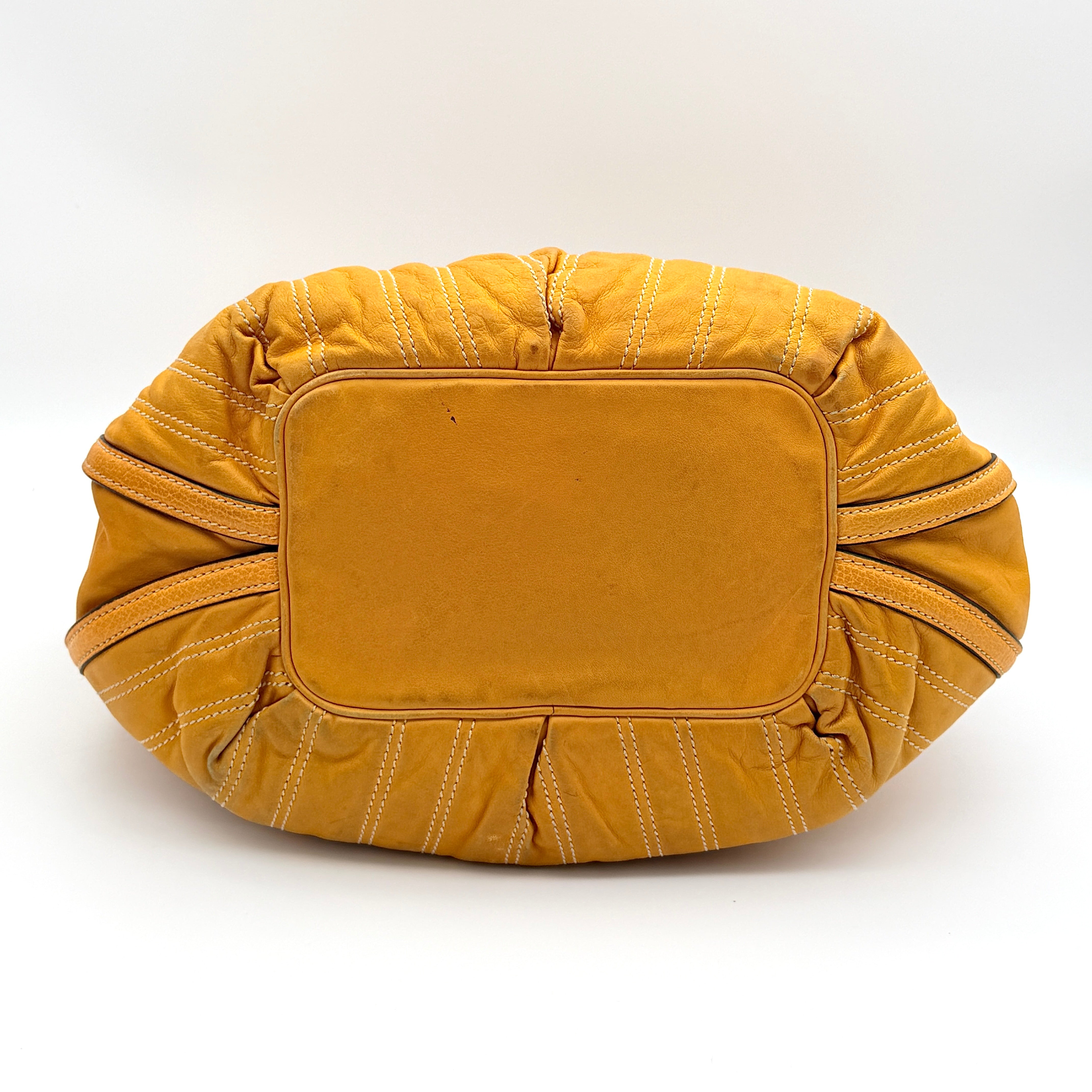 Celine Stripe Hobo Shoulder Bag in yellow leather with vertical stitching and signature gold-tone medallion, shown with dual handles.
