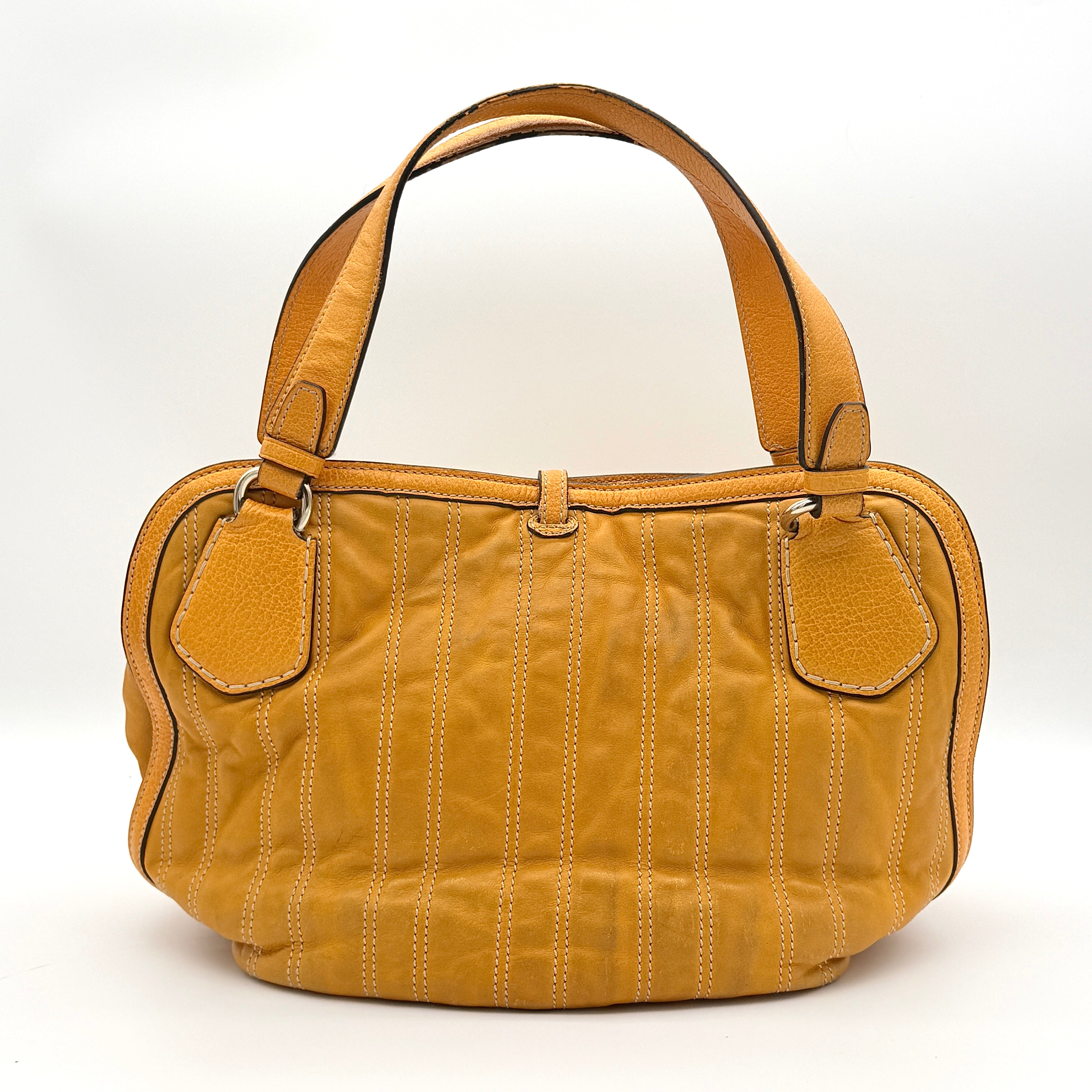 Celine Stripe Hobo Shoulder Bag in yellow leather with vertical stitching and signature gold-tone medallion, shown with dual handles.