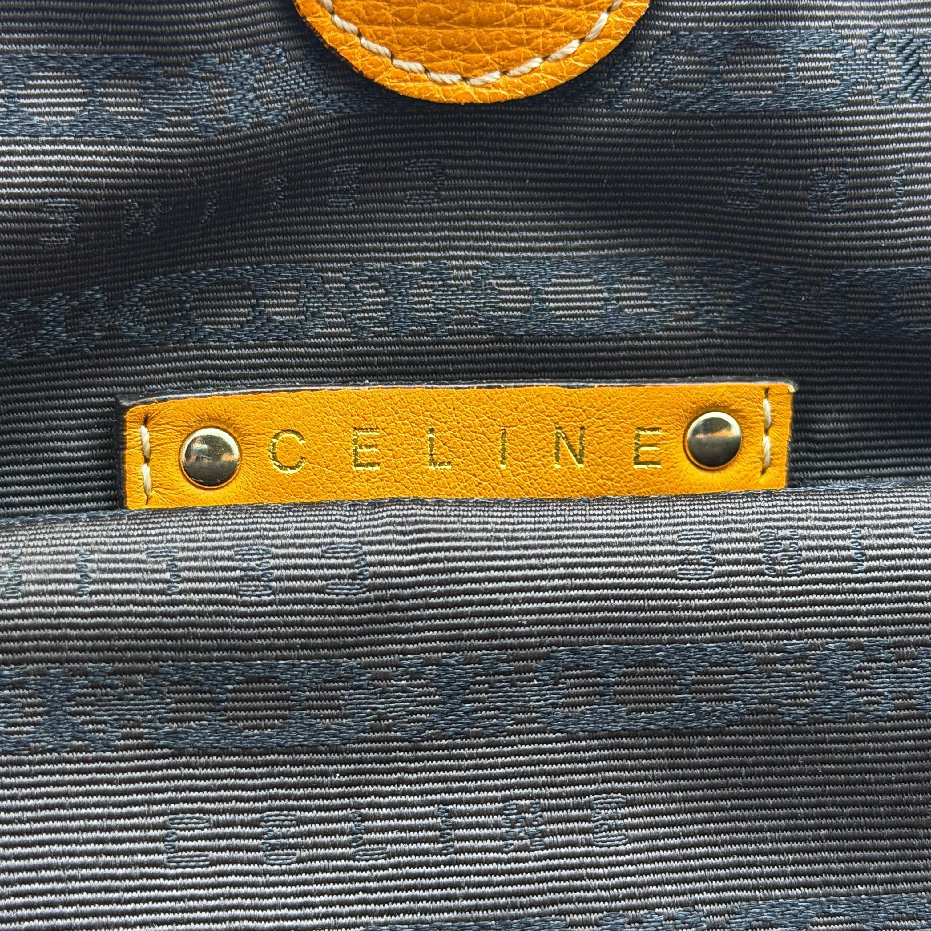 Celine Stripe Hobo Shoulder Bag in yellow leather with vertical stitching and signature gold-tone medallion, shown with dual handles.