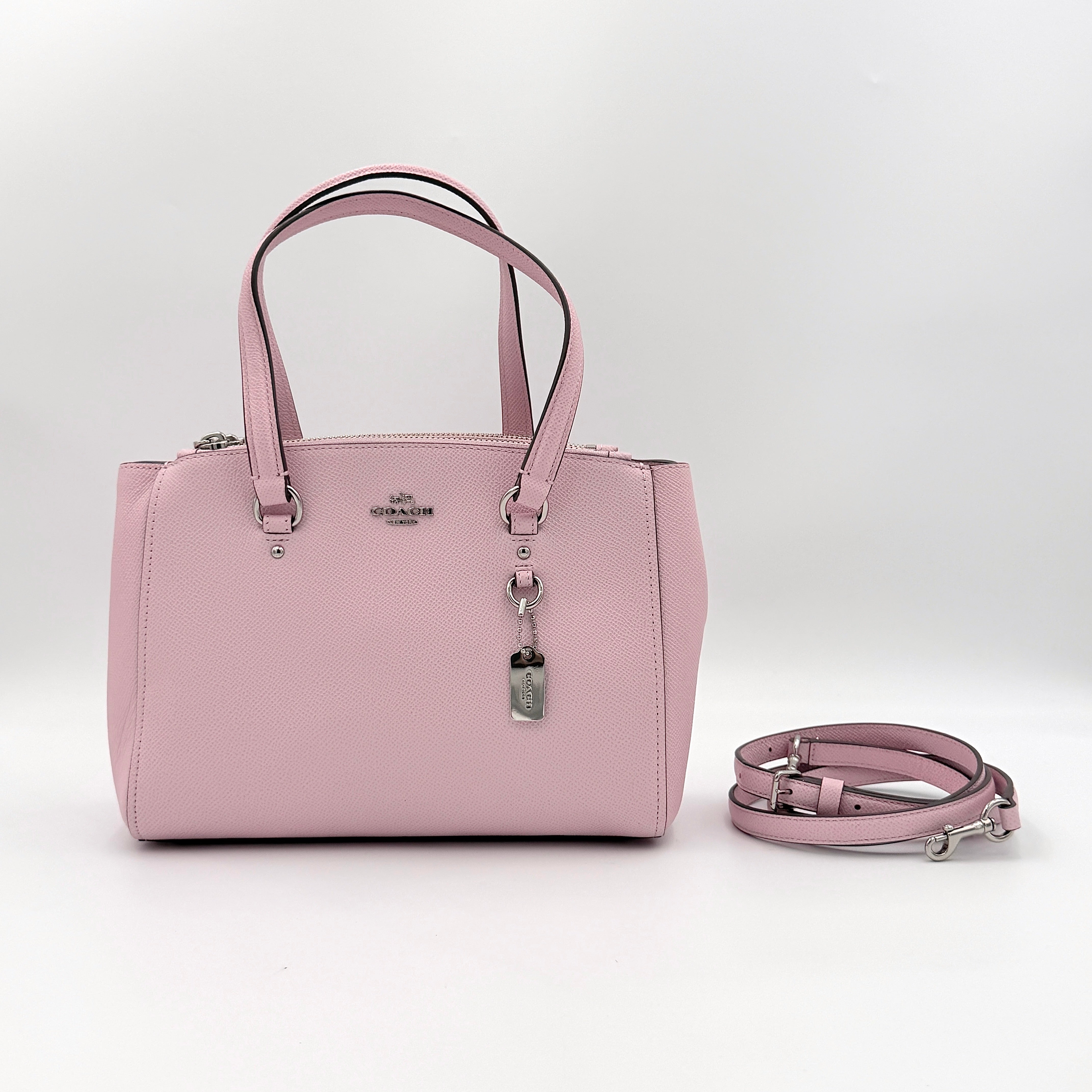 Coach Stanton 26 Carryall in blush pink grained leather with dual handles, silver hardware, and detachable strap.