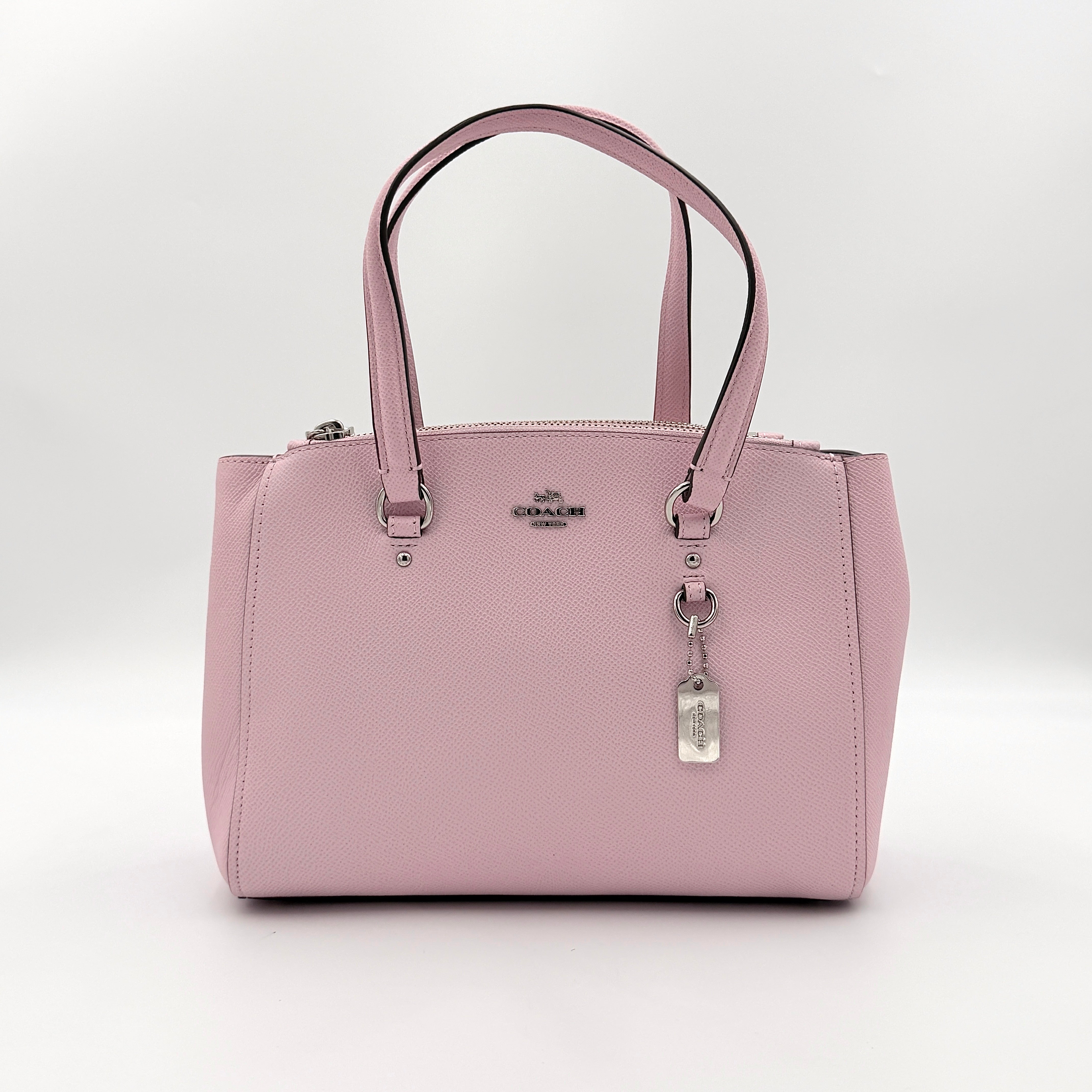Coach Stanton 26 Carryall in blush pink grained leather with dual handles, silver hardware, and detachable strap.