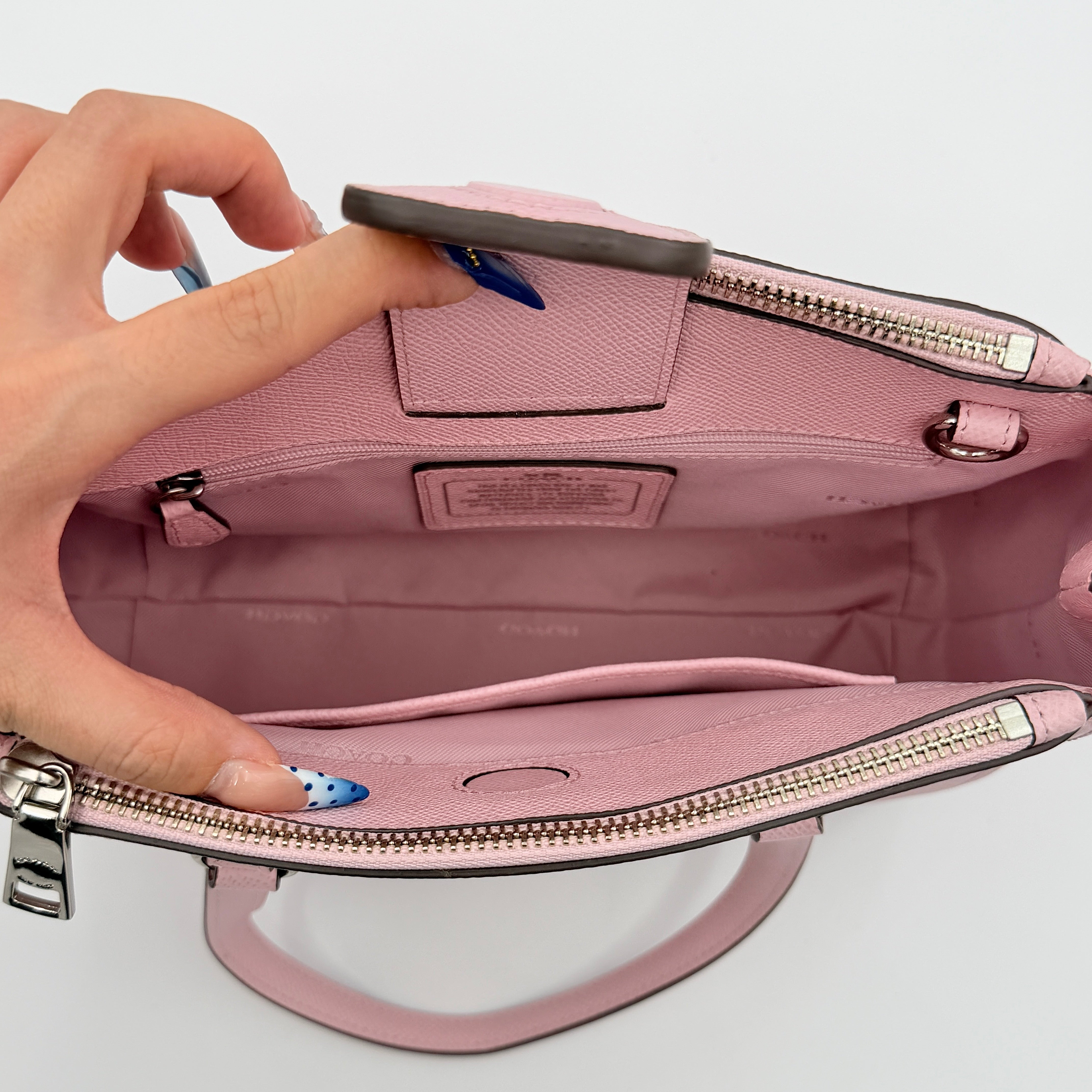 Coach Stanton 26 Carryall in blush pink grained leather with dual handles, silver hardware, and detachable strap.
