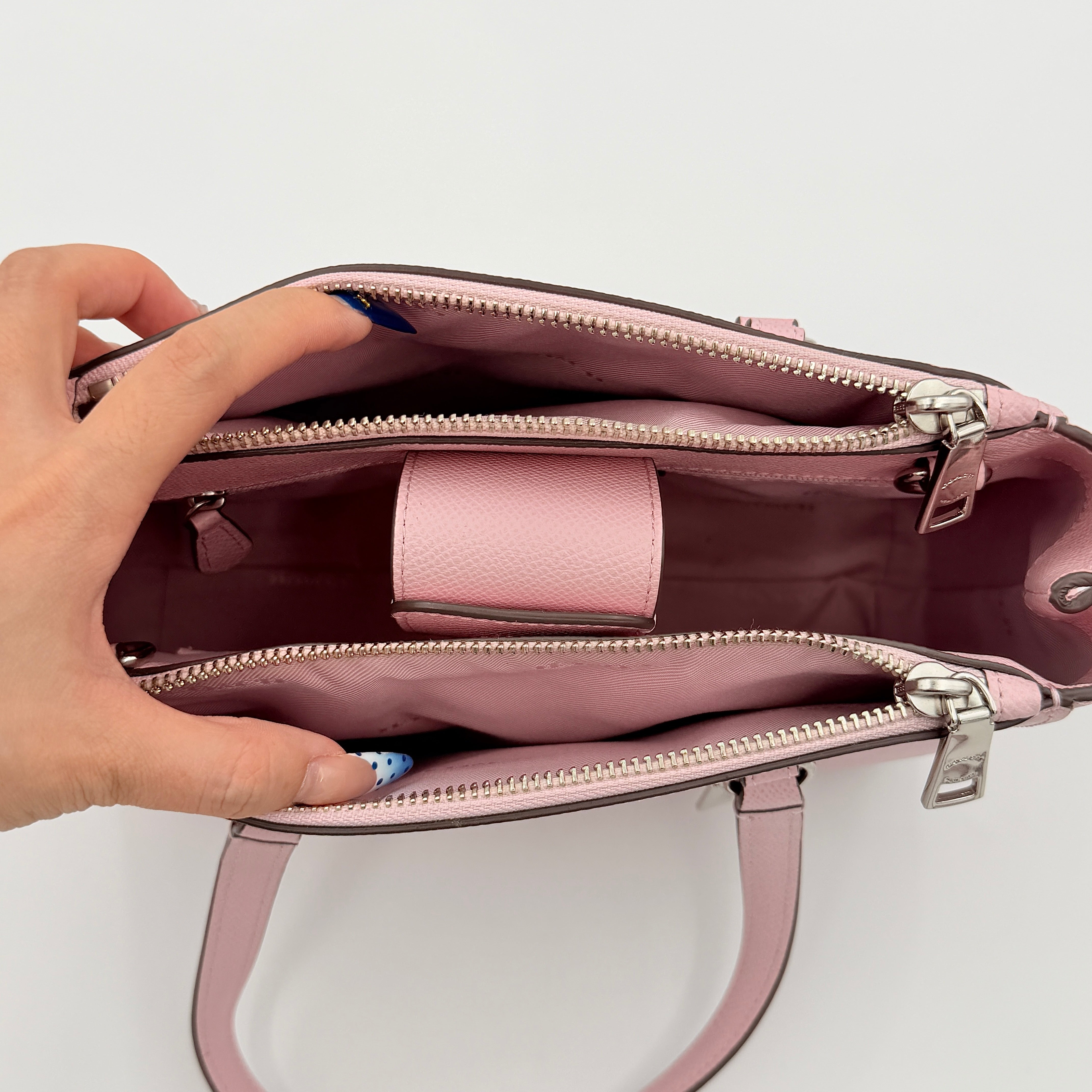 Coach Stanton 26 Carryall in blush pink grained leather with dual handles, silver hardware, and detachable strap.