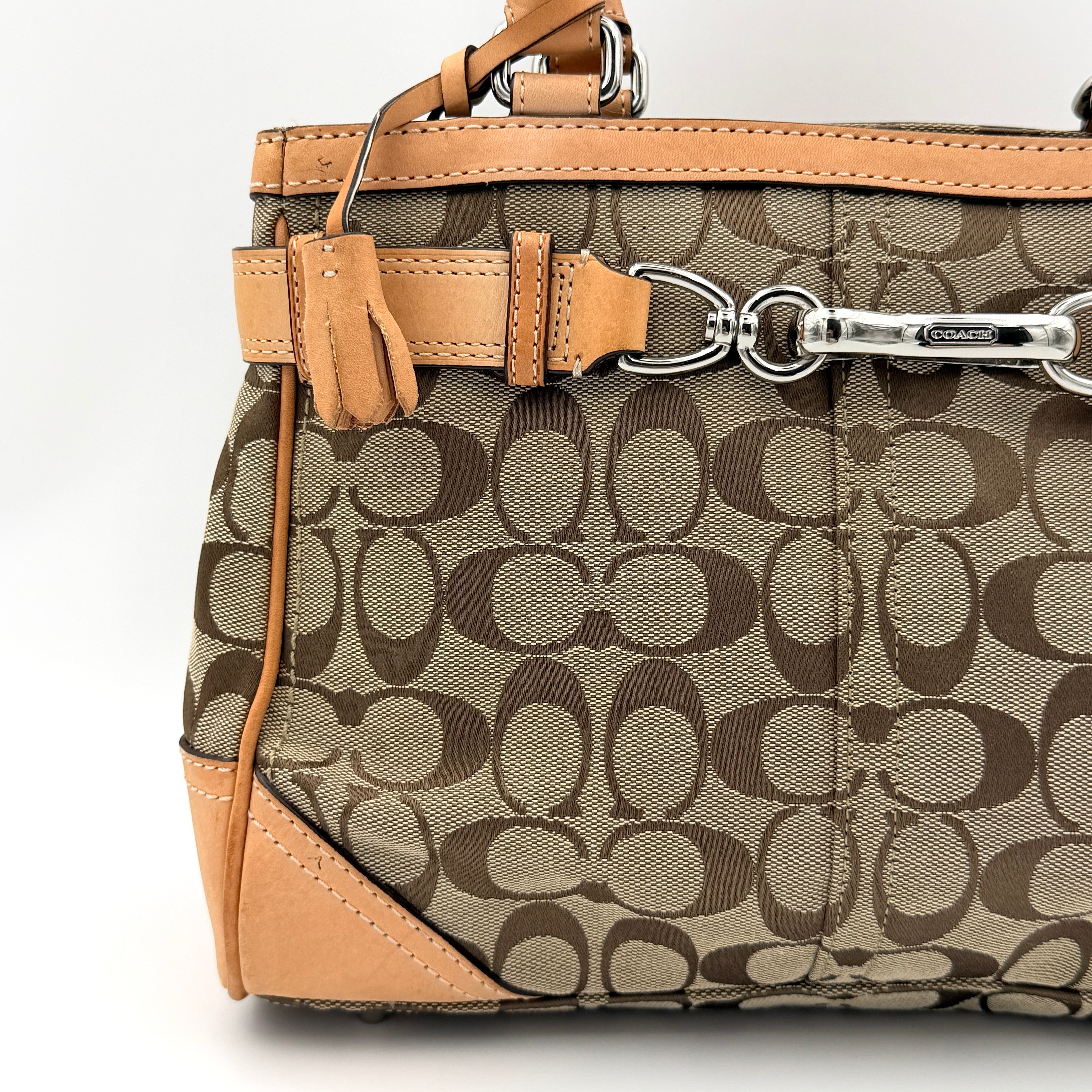 Coach Signature Hampton Clip Shoulder Bag in beige and brown jacquard canvas with leather trim and silver-tone hardware, displayed upright with twin handles.