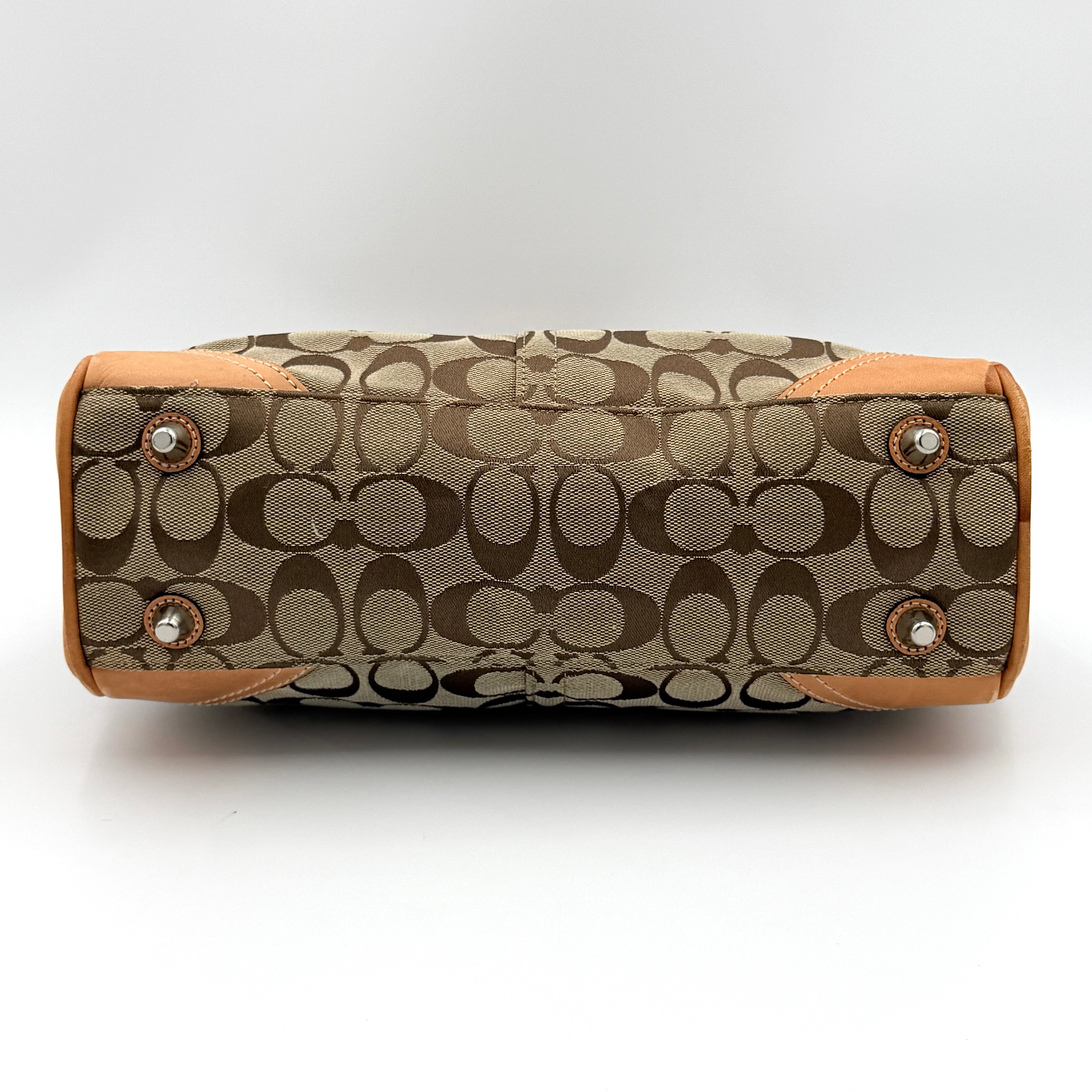Coach Signature Hampton Clip Shoulder Bag in beige and brown jacquard canvas with leather trim and silver-tone hardware, displayed upright with twin handles.