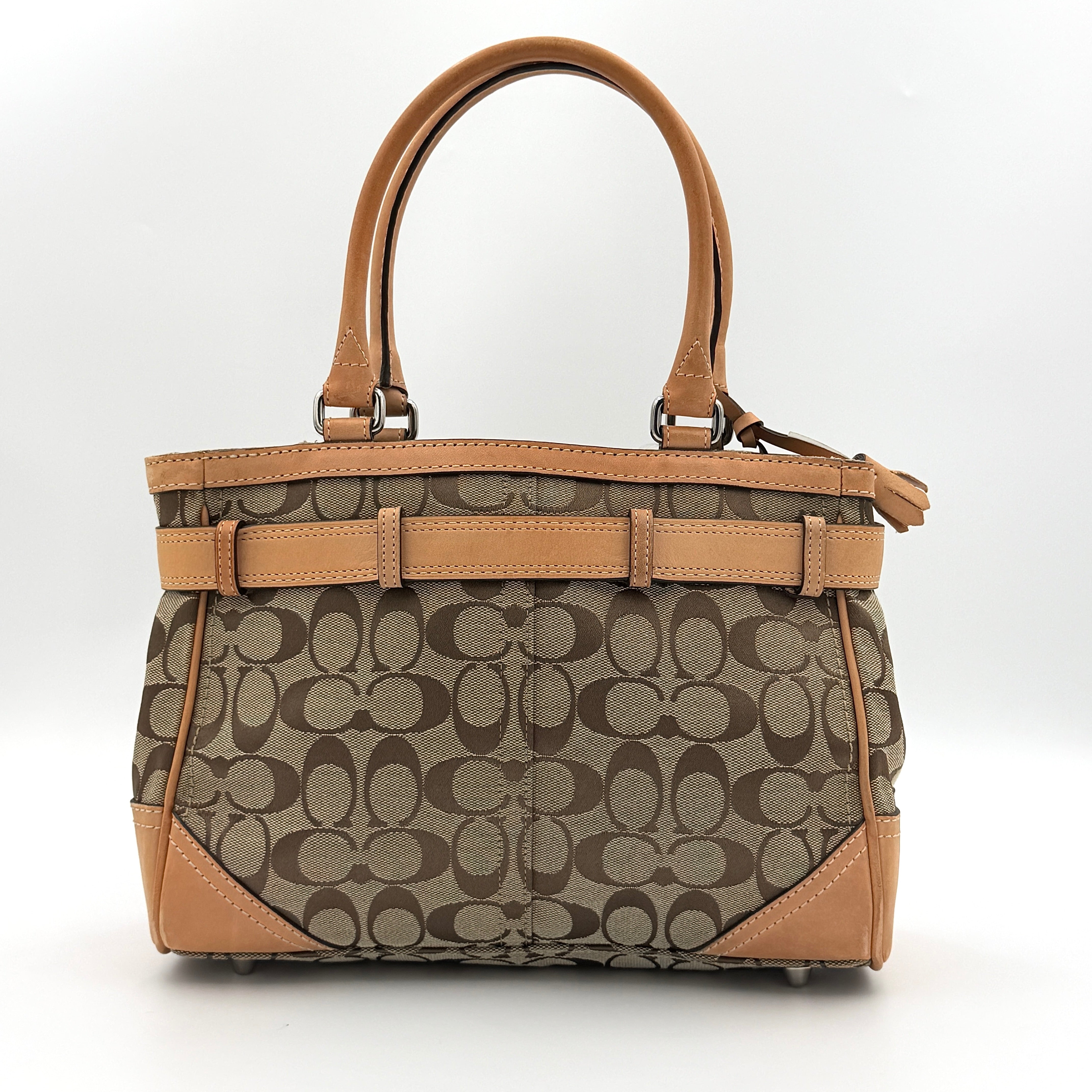 Coach Signature Hampton Clip Shoulder Bag in beige and brown jacquard canvas with leather trim and silver-tone hardware, displayed upright with twin handles.
