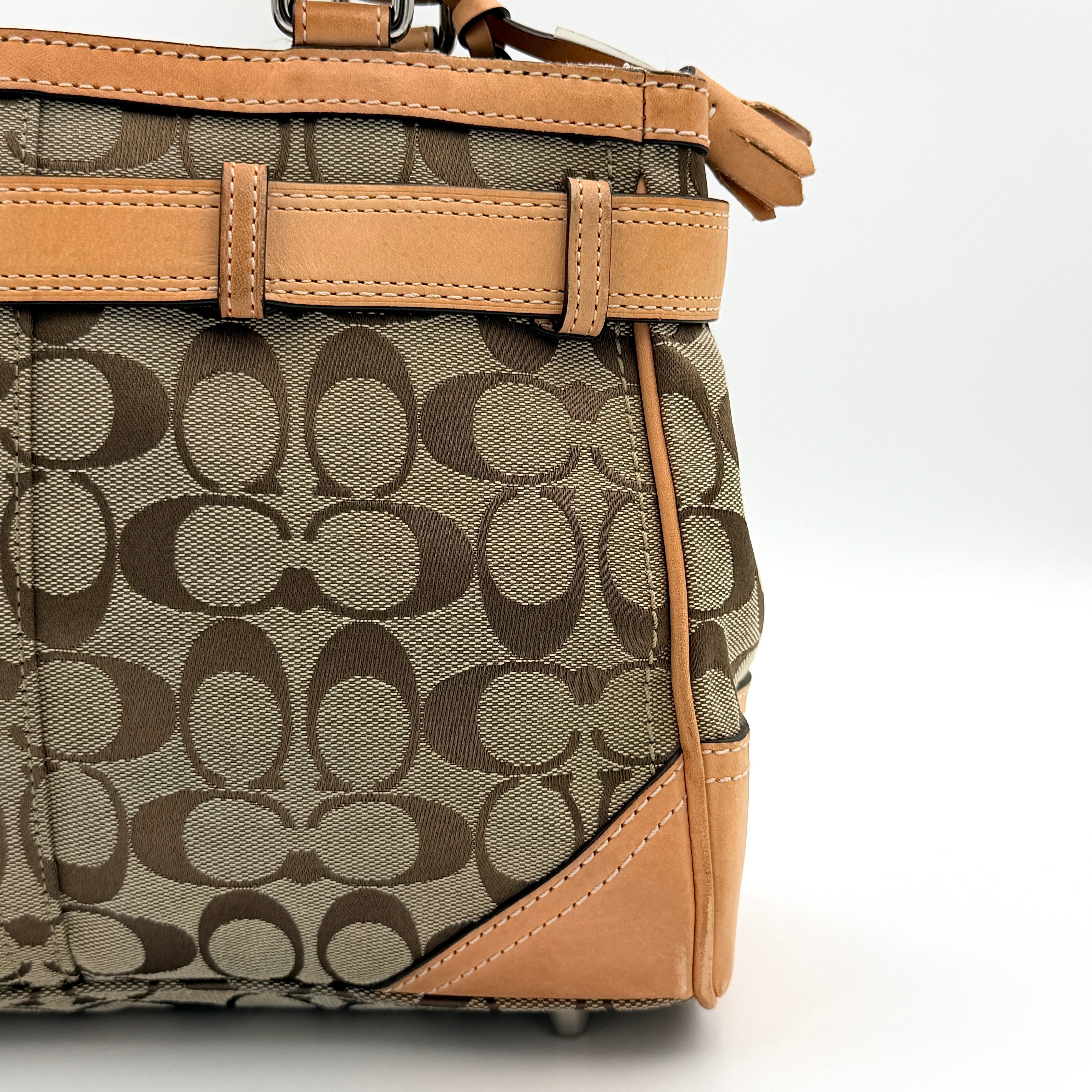 Coach Signature Hampton Clip Shoulder Bag in beige and brown jacquard canvas with leather trim and silver-tone hardware, displayed upright with twin handles.