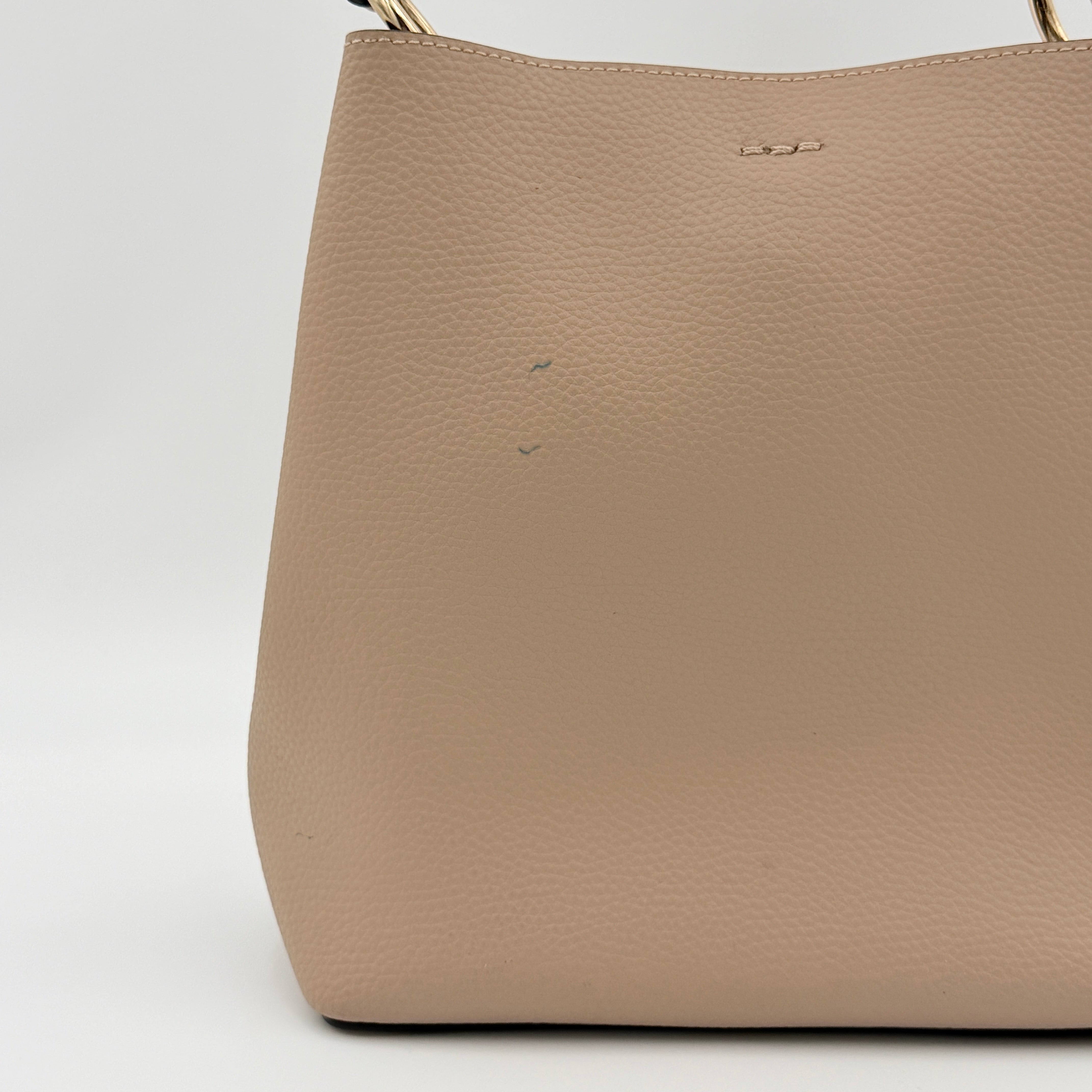 Coach Town Bucket Bag in taupe pebbled leather with gold-tone hardware and Coach hangtag, shown against a white background.