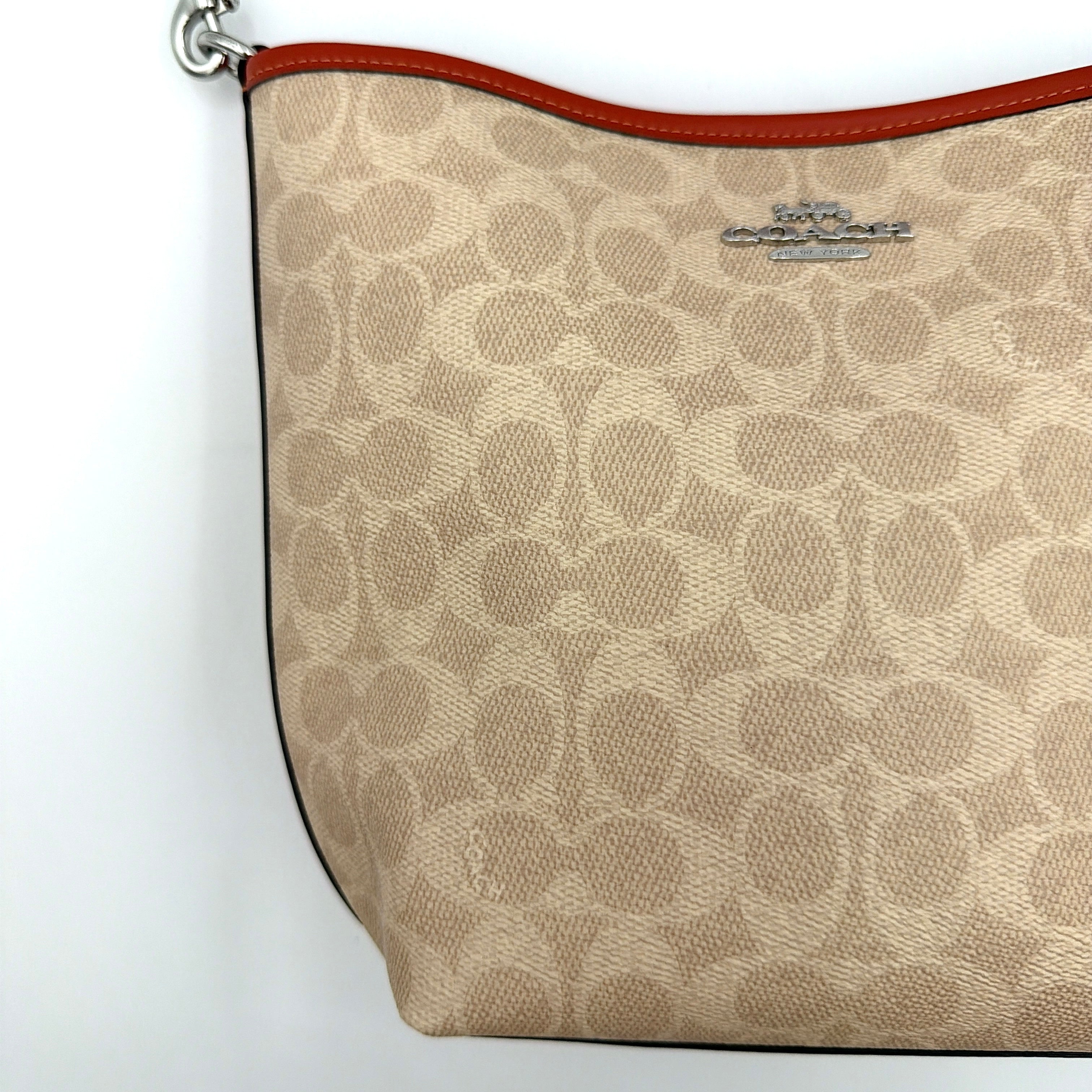 Coach 2Way City Bucket Shoulder Bag in beige signature canvas with red leather accents, detachable strap, and silver-tone hardware.