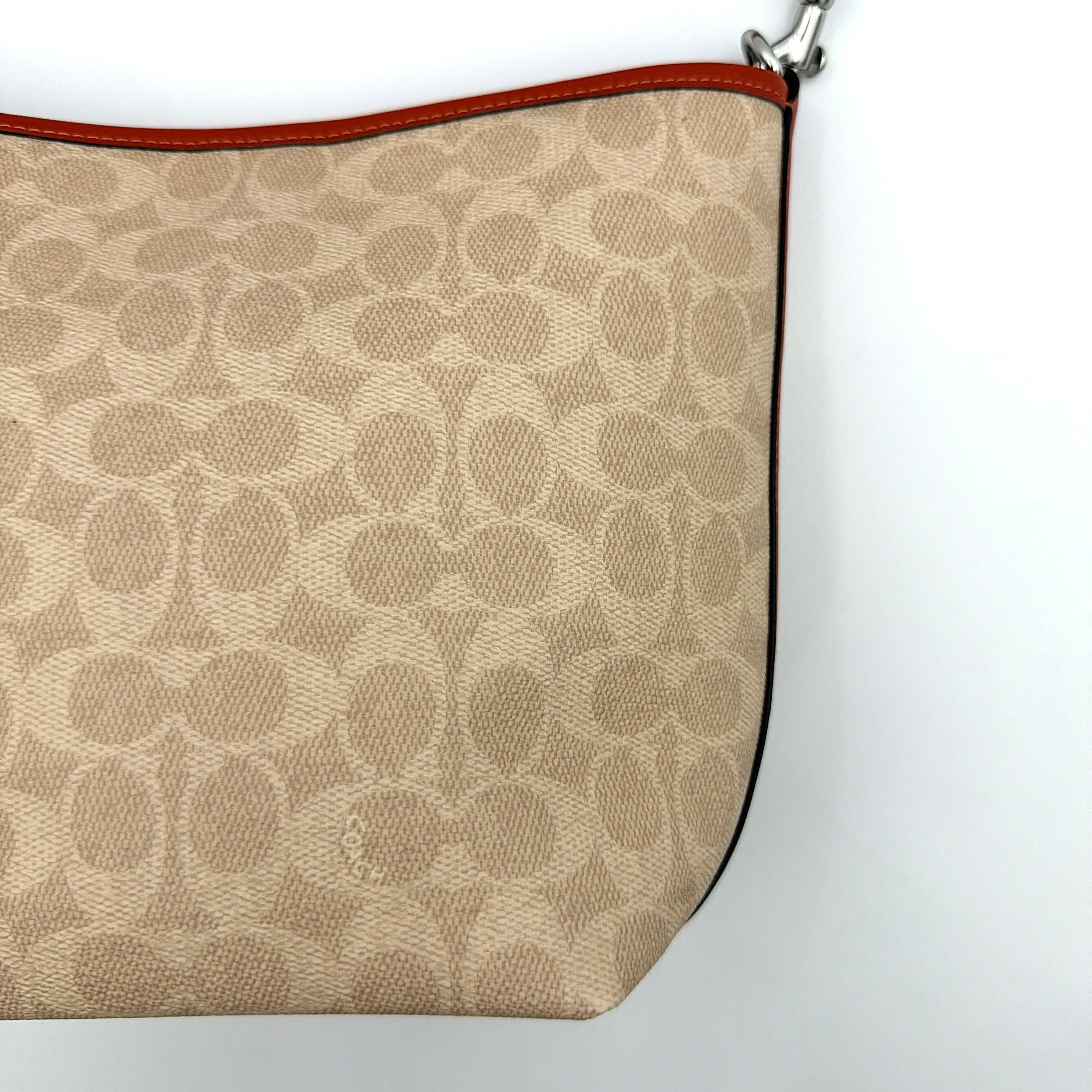 Coach 2Way City Bucket Shoulder Bag in beige signature canvas with red leather accents, detachable strap, and silver-tone hardware.