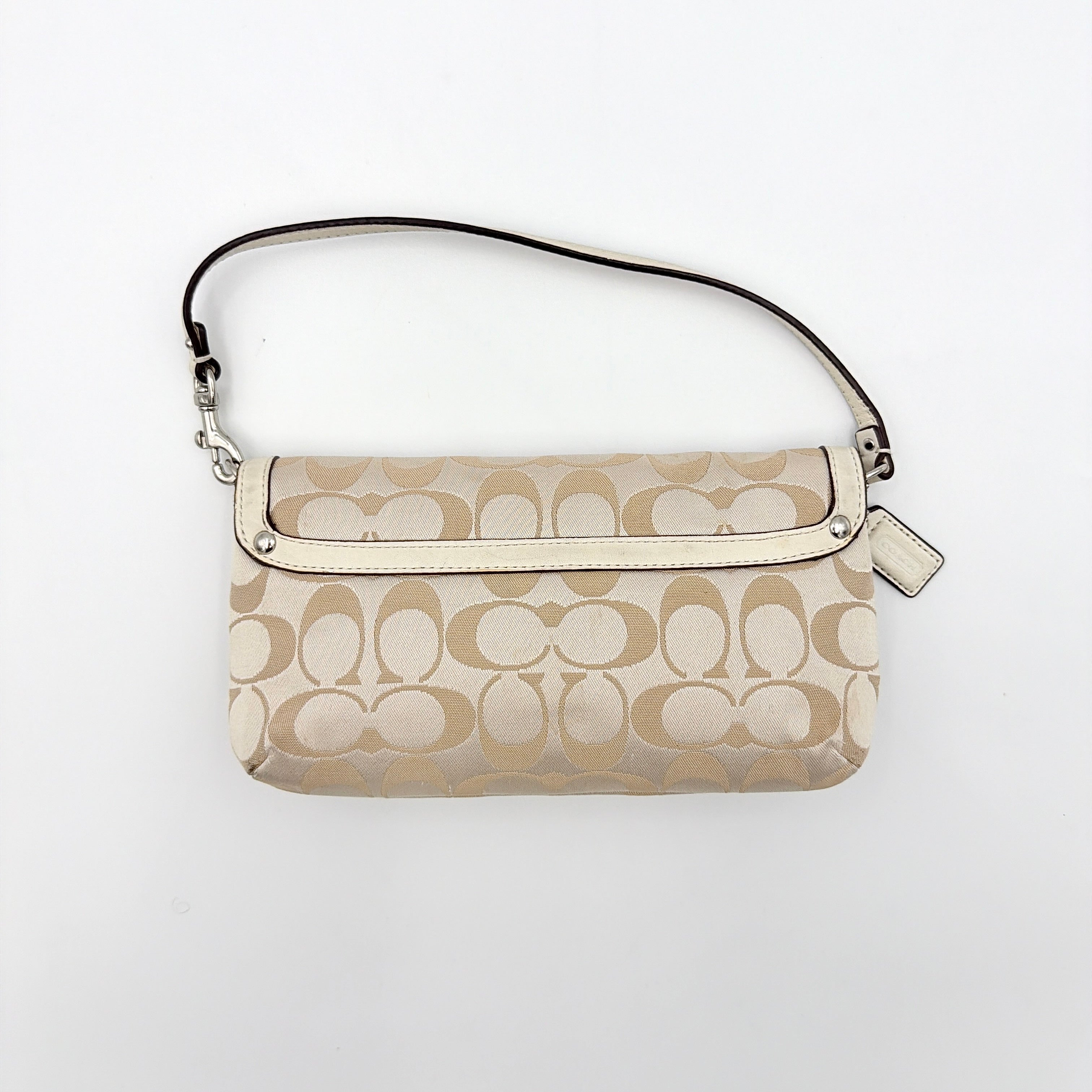 Coach Signature Kristin Shoulder Bag in beige and white jacquard canvas with white leather trim, presented with a polished silver push-lock clasp.