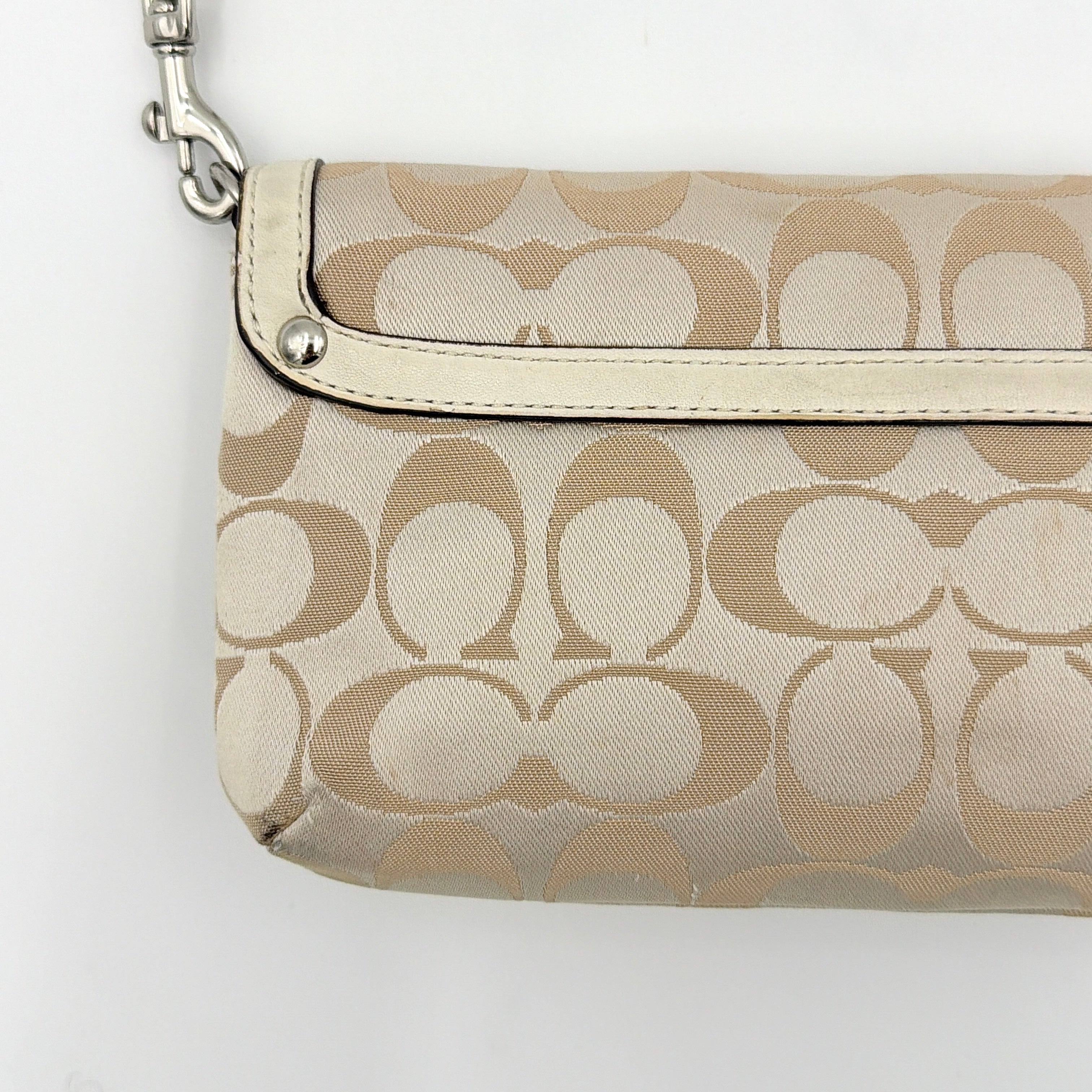 Coach Signature Kristin Shoulder Bag in beige and white jacquard canvas with white leather trim, presented with a polished silver push-lock clasp.