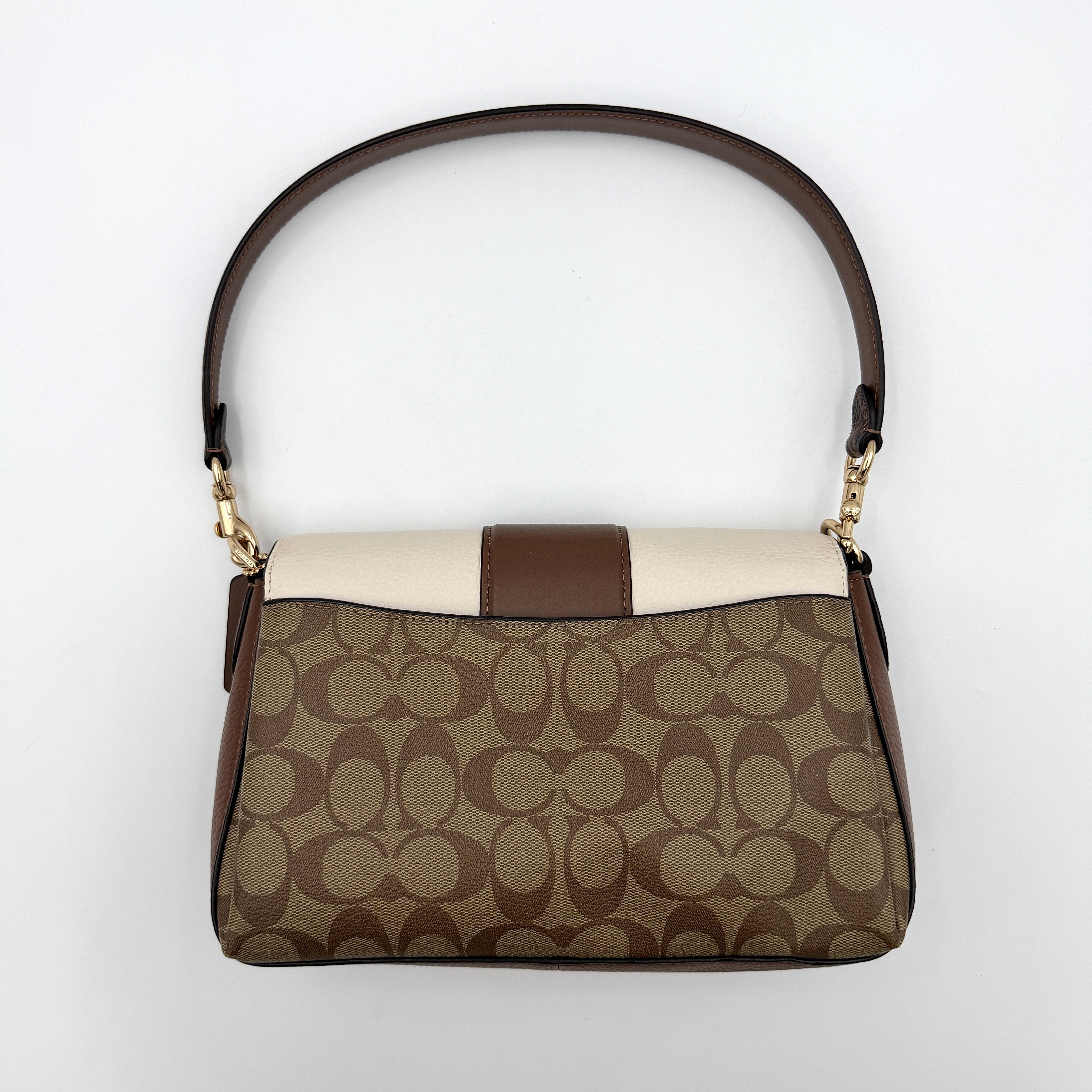 Coach Signature Grace Shoulder Bag in beige and white leather with monogram canvas and gold hardware, displayed with structured silhouette and top handle.