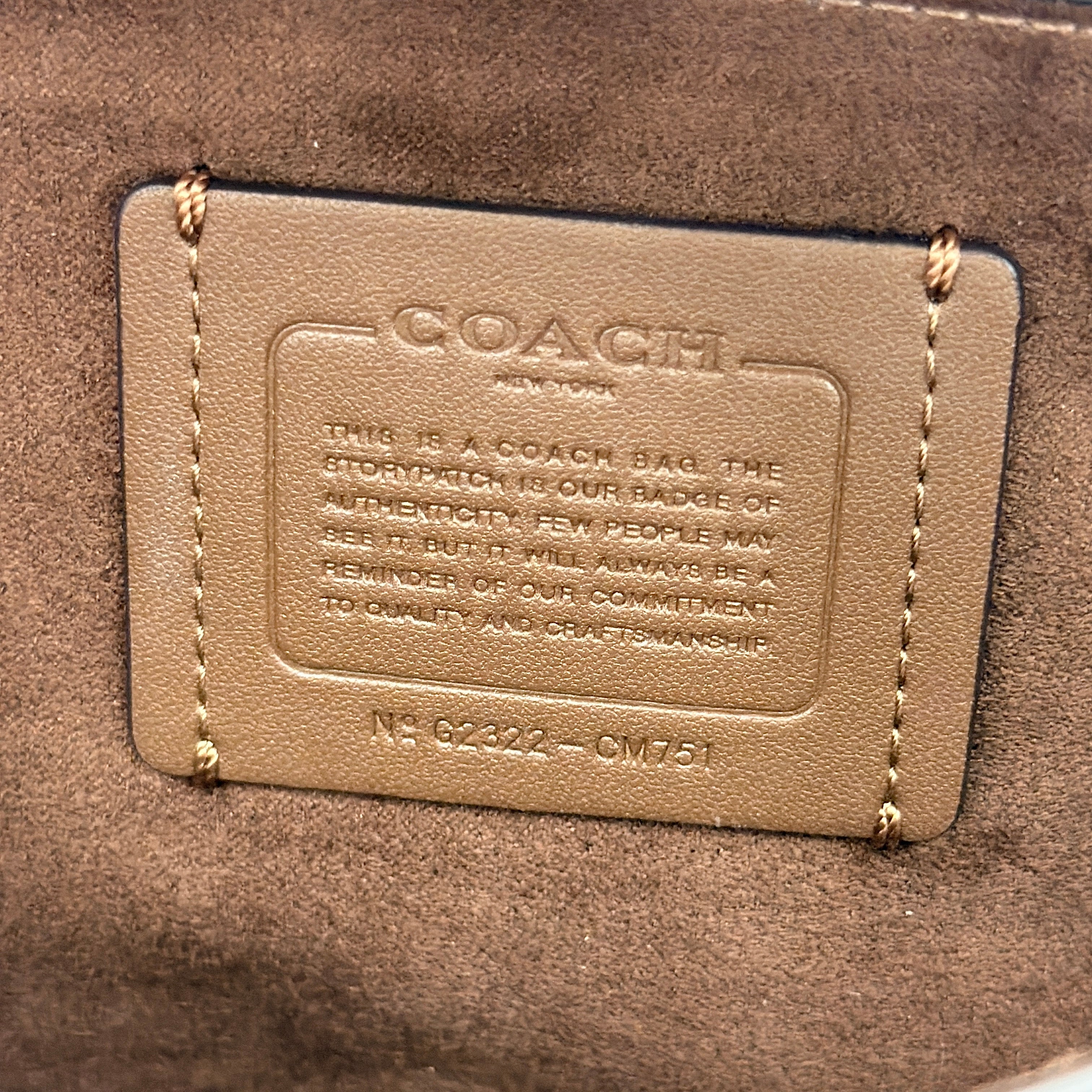 Coach Signature Grace Shoulder Bag in beige and white leather with monogram canvas and gold hardware, displayed with structured silhouette and top handle.