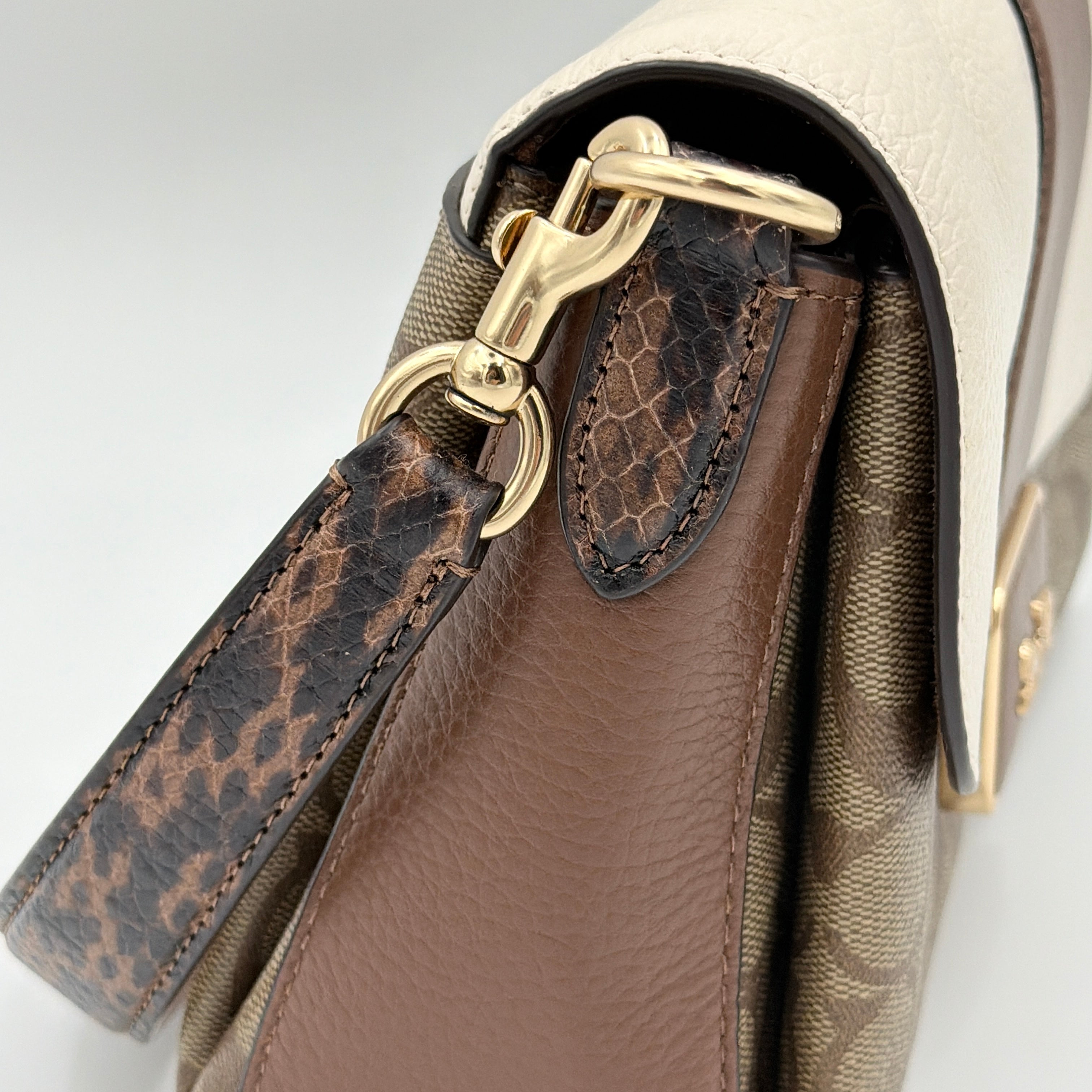 Coach Signature Grace Shoulder Bag in beige and white leather with monogram canvas and gold hardware, displayed with structured silhouette and top handle.