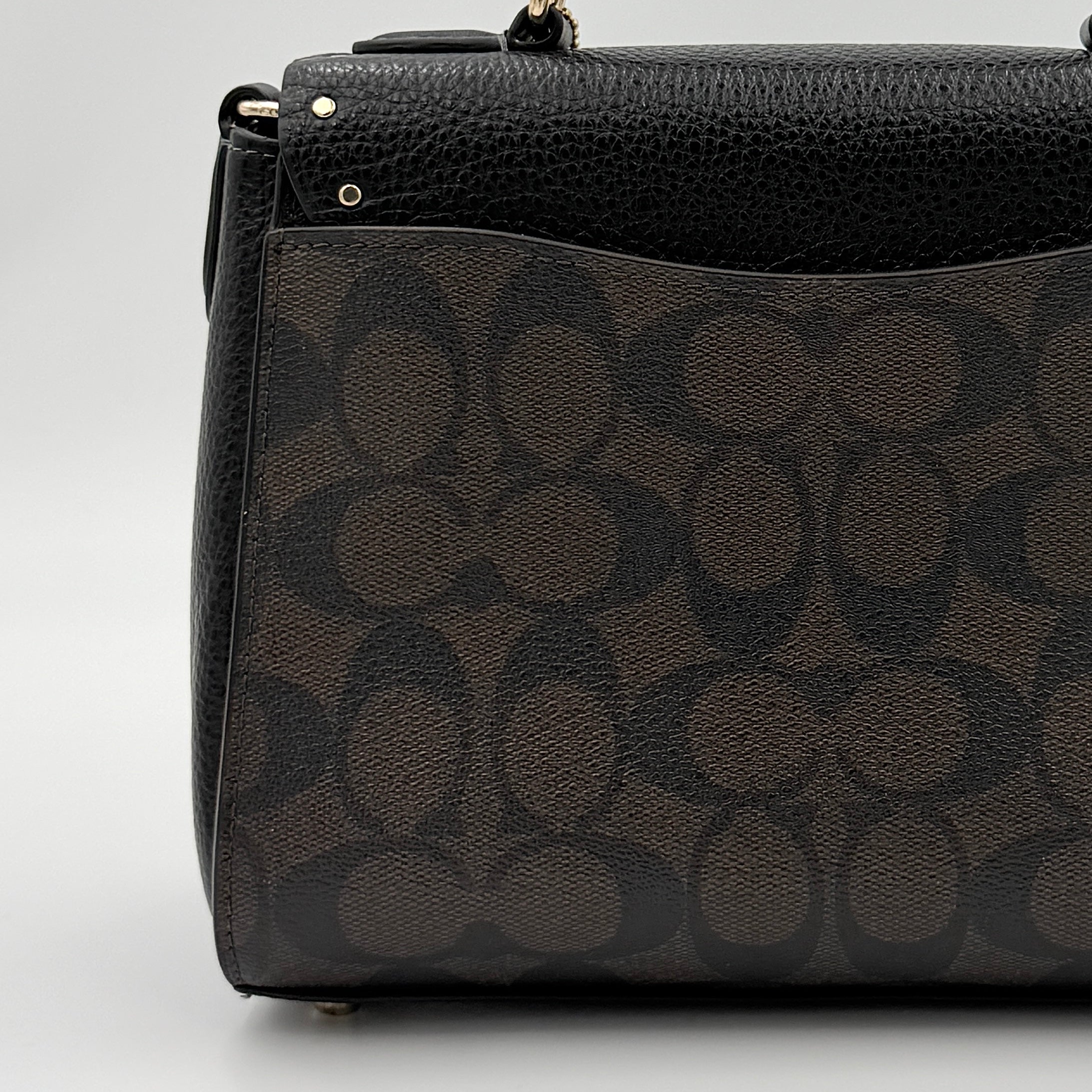 Coach Morgan Top Handle Bag in brown and black signature canvas with pebbled leather, gold hardware and detachable strap displayed alongside a Coach dustbag.