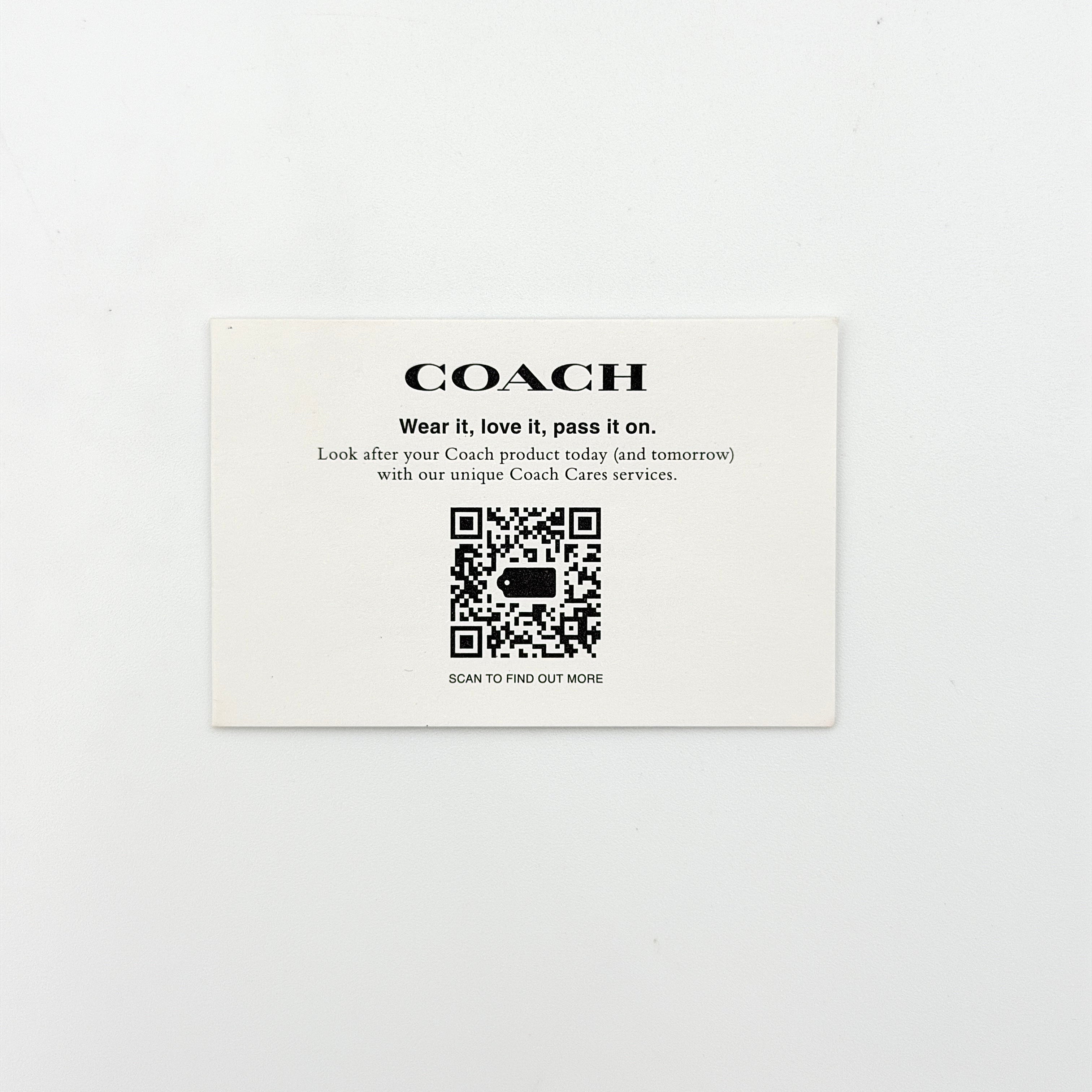 Coach Morgan Top Handle Bag in brown and black signature canvas with pebbled leather, gold hardware and detachable strap displayed alongside a Coach dustbag.