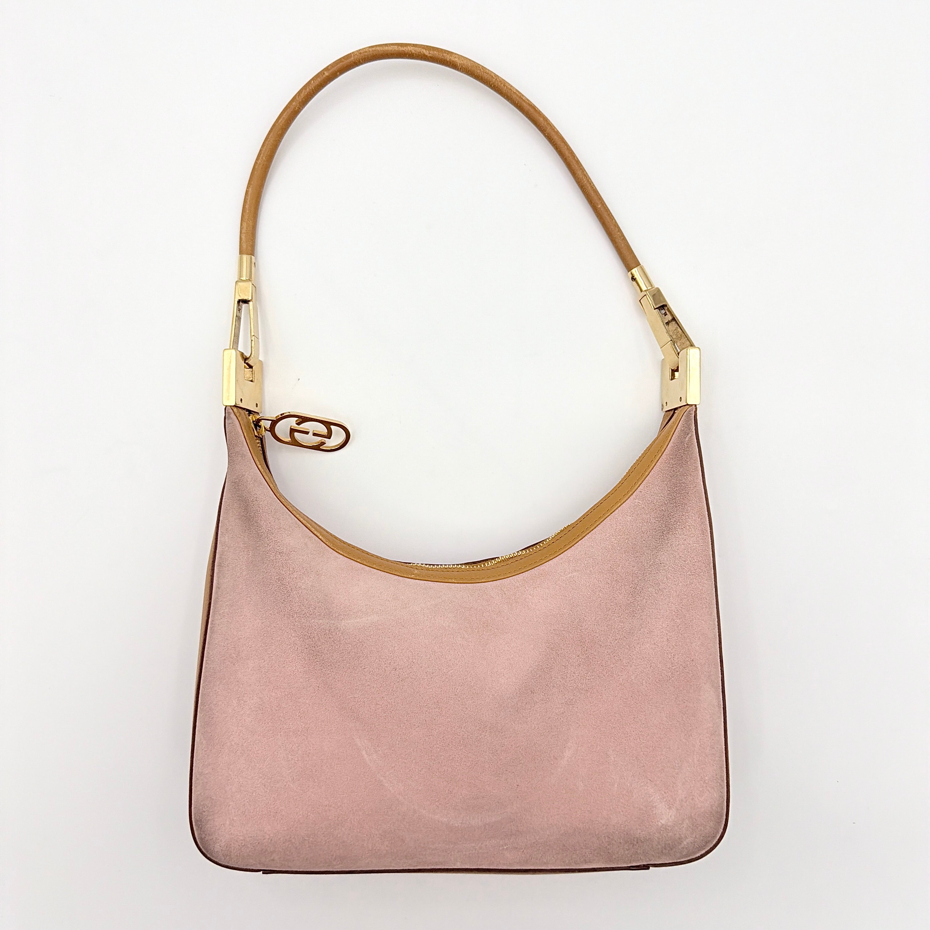 Gucci hobo shoulder bag in blush pink suede with tan leather trim and gold hardware, displayed against a white background.