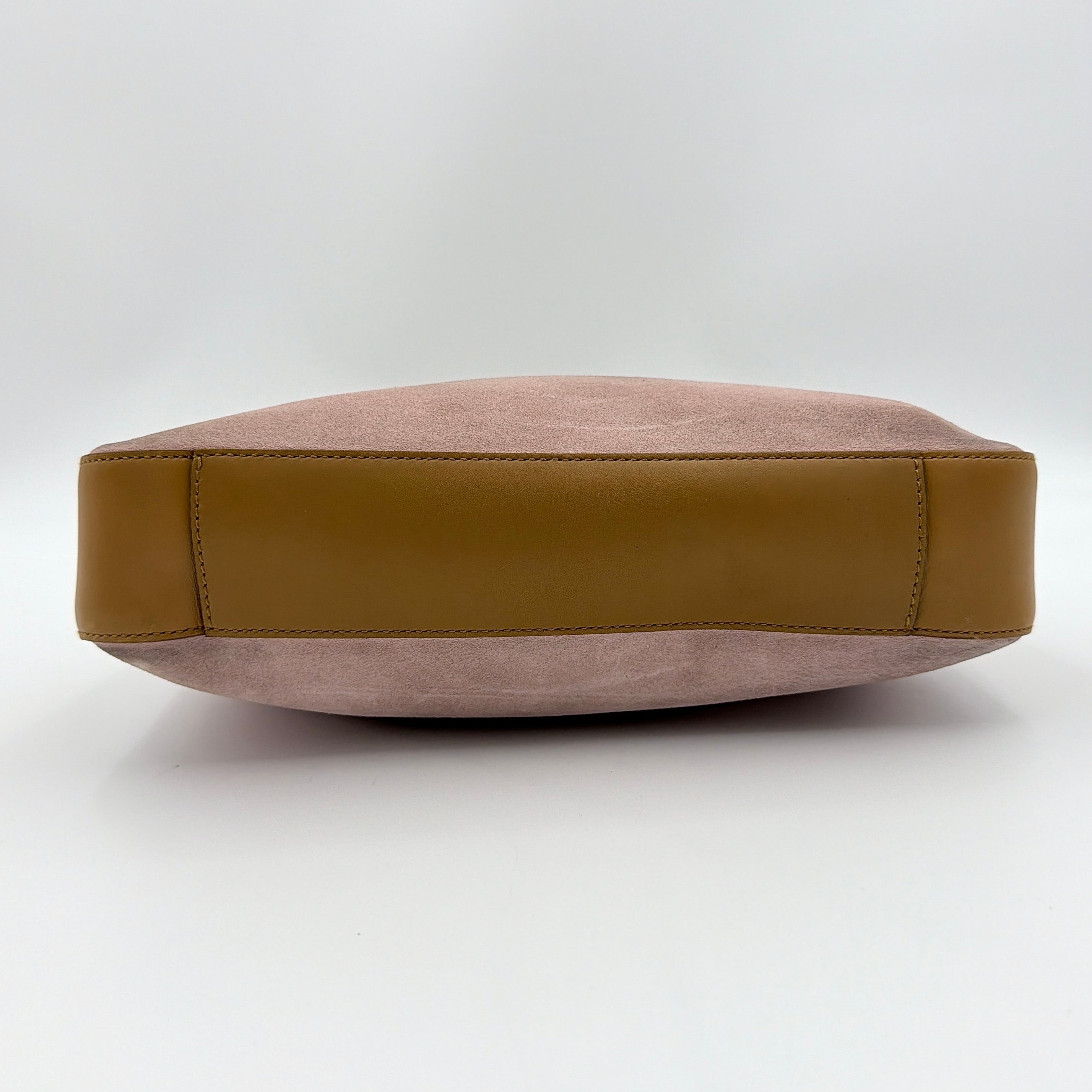 Gucci hobo shoulder bag in blush pink suede with tan leather trim and gold hardware, displayed against a white background.