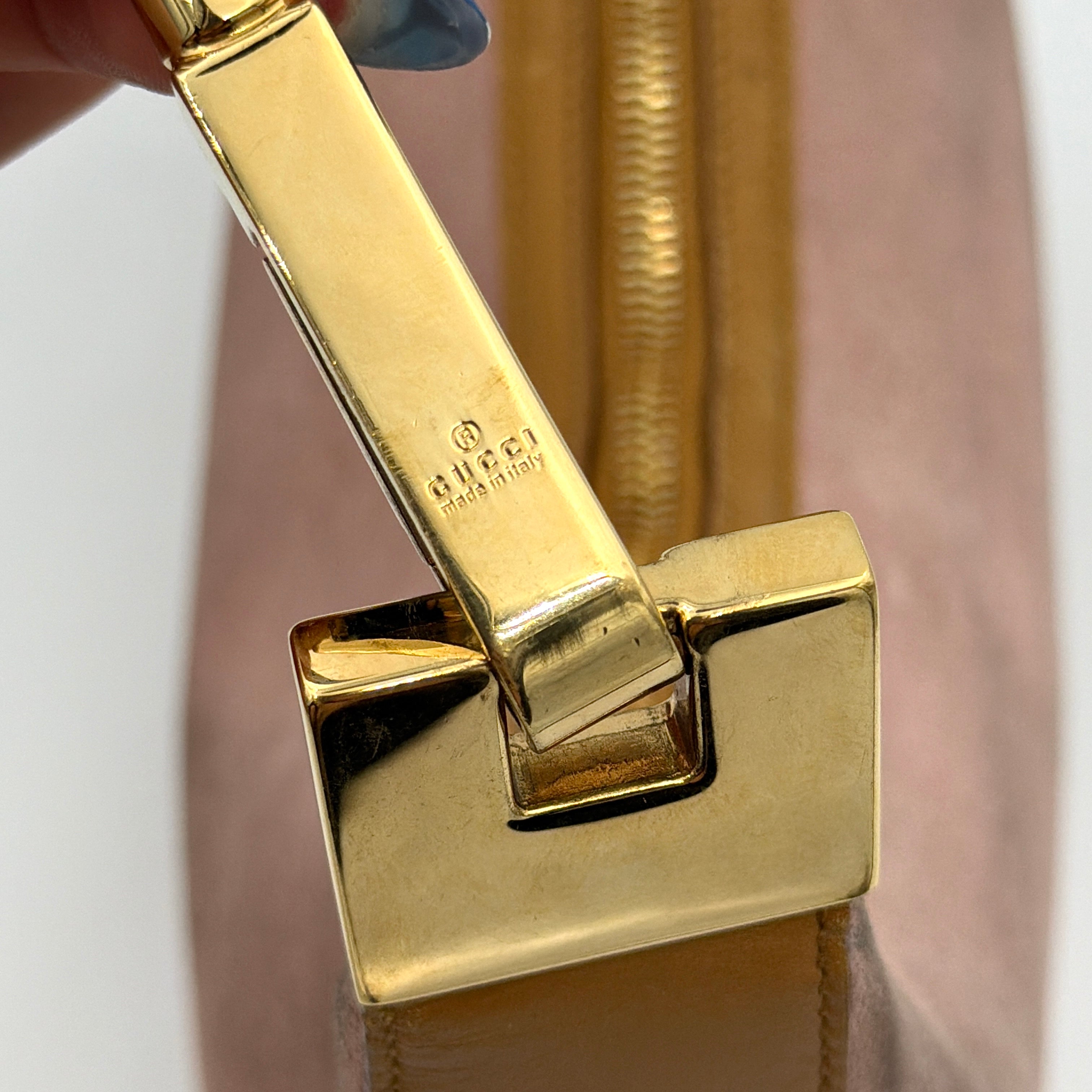 Gucci hobo shoulder bag in blush pink suede with tan leather trim and gold hardware, displayed against a white background.