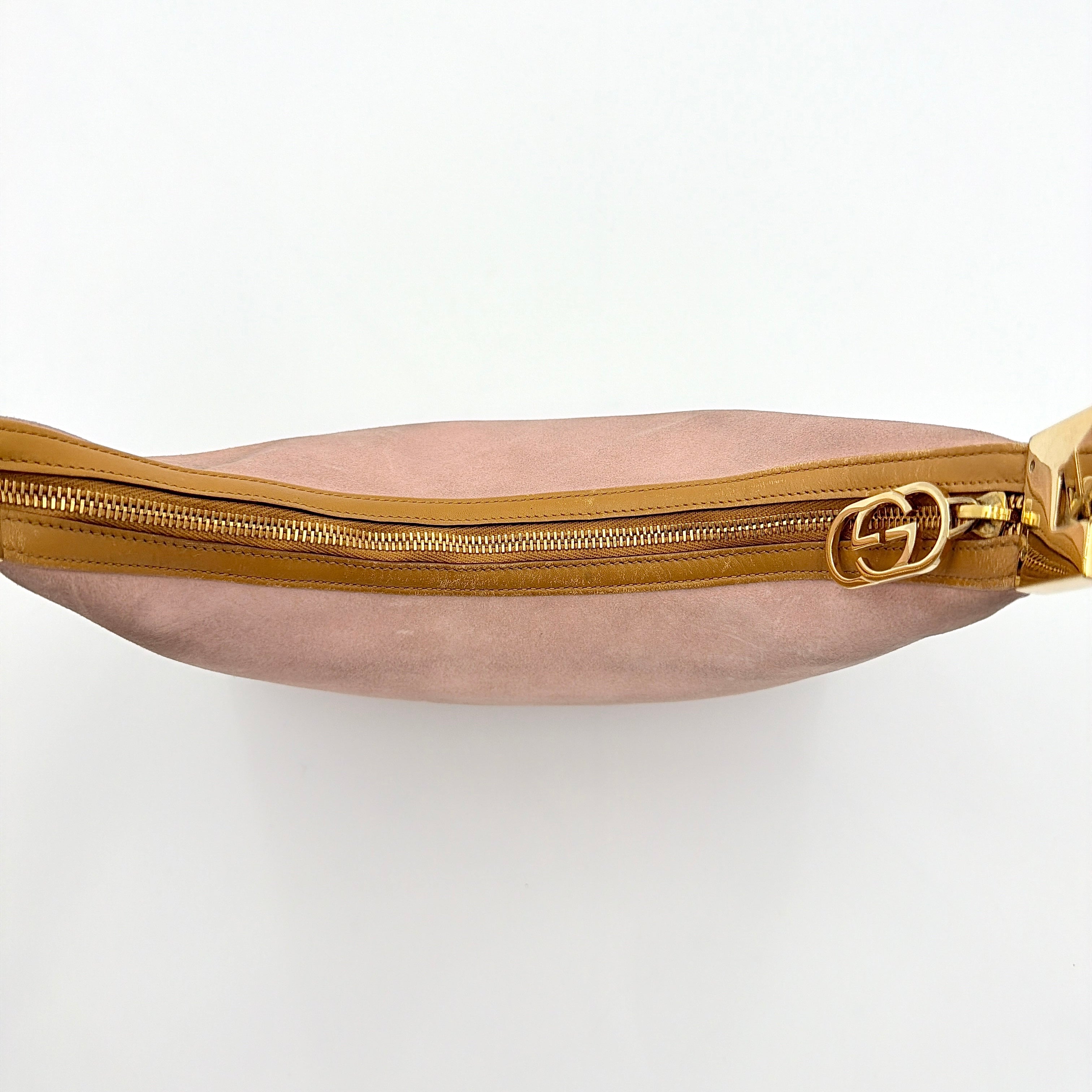 Gucci hobo shoulder bag in blush pink suede with tan leather trim and gold hardware, displayed against a white background.
