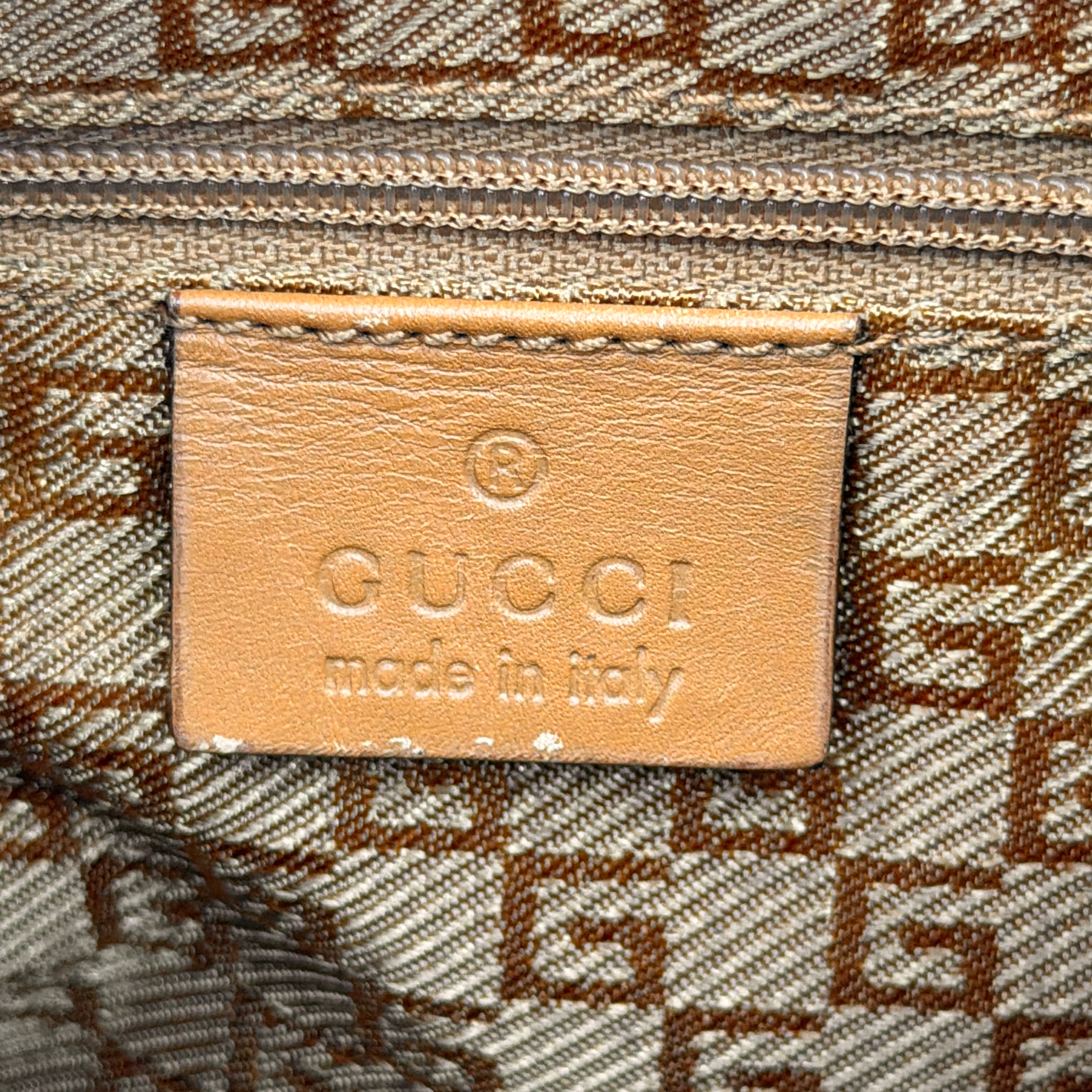 Gucci hobo shoulder bag in blush pink suede with tan leather trim and gold hardware, displayed against a white background.