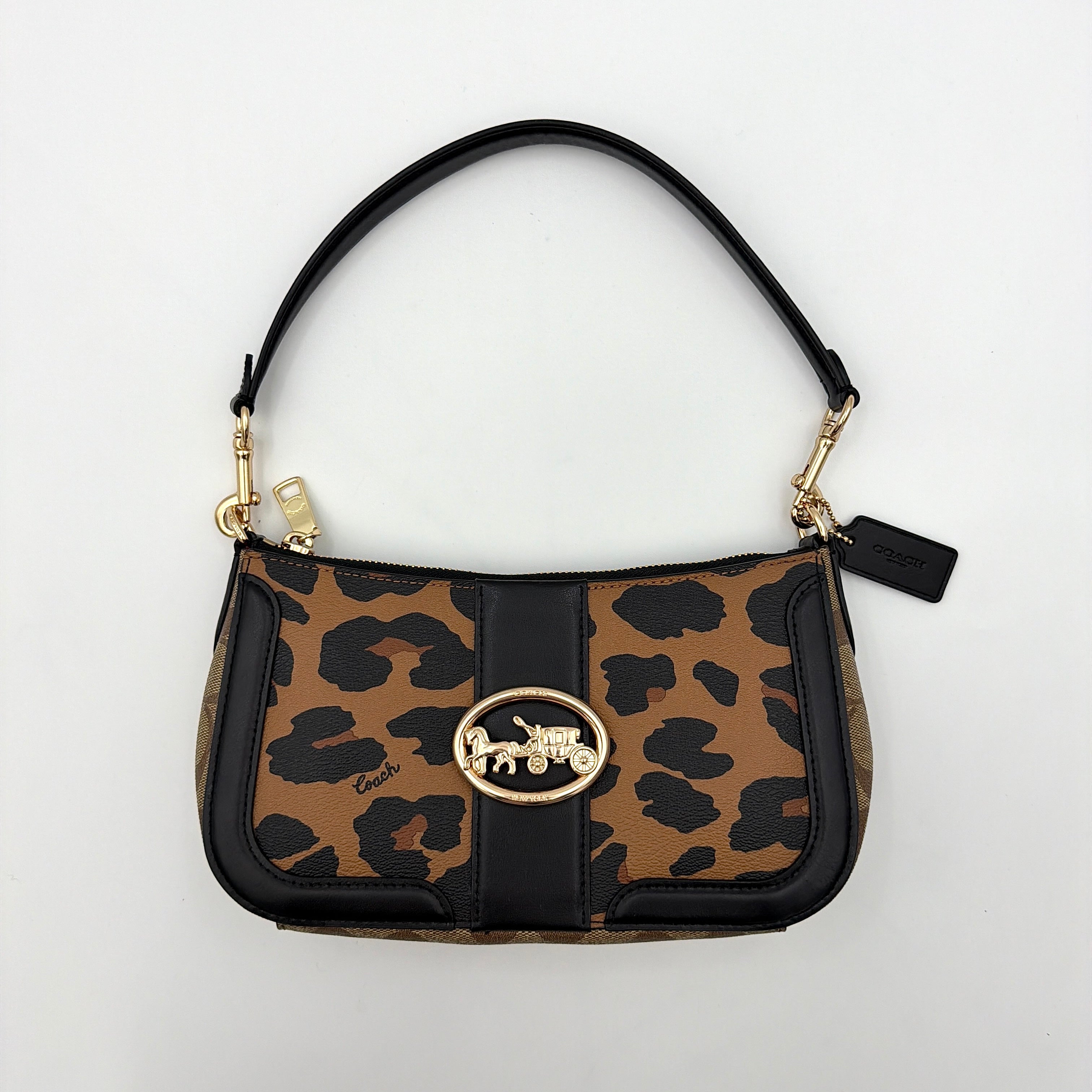 Coach Georgie Shoulder Bag in brown and black leopard print with gold horse and carriage medallion, displayed with its detachable chain and leather strap.