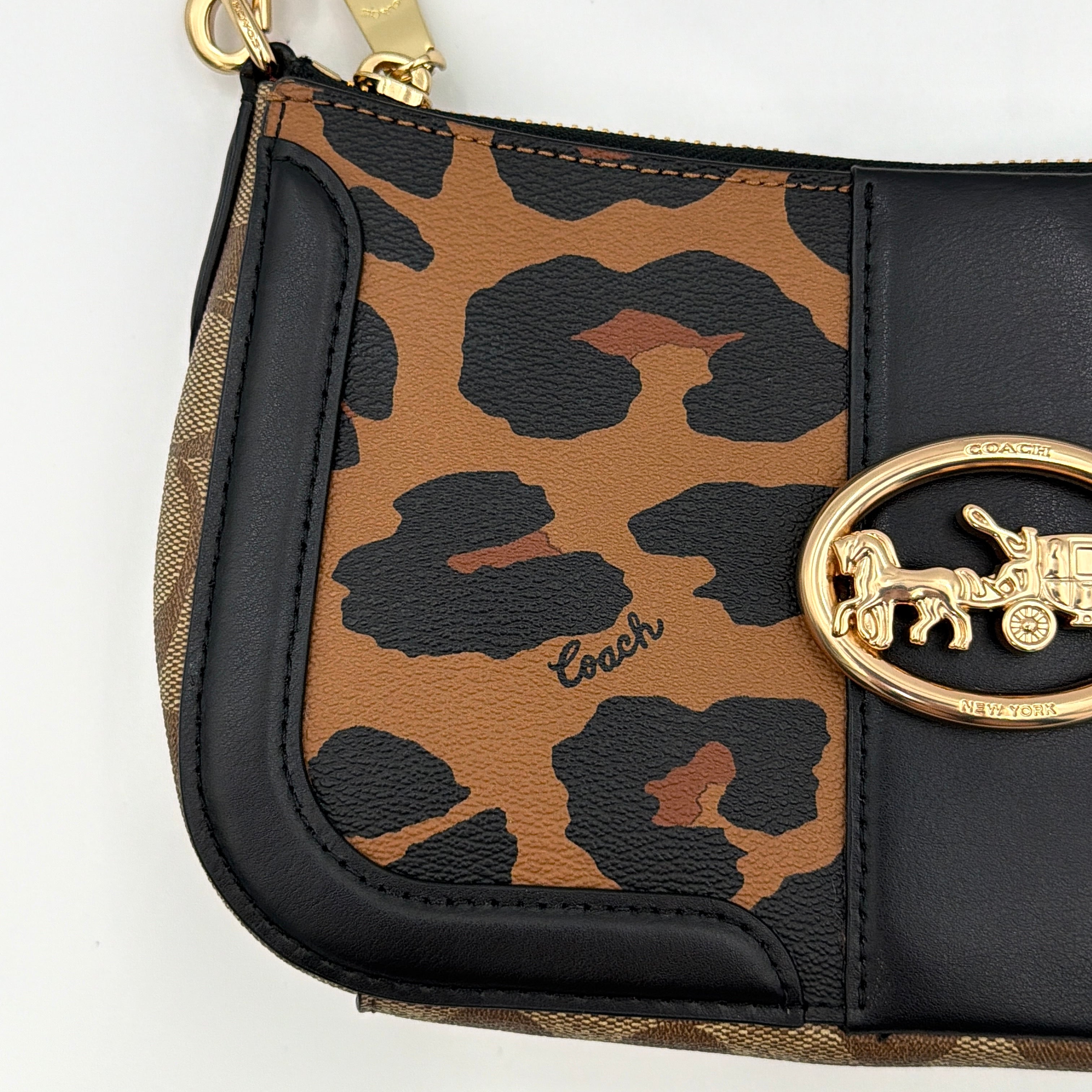 Coach Georgie Shoulder Bag in brown and black leopard print with gold horse and carriage medallion, displayed with its detachable chain and leather strap.
