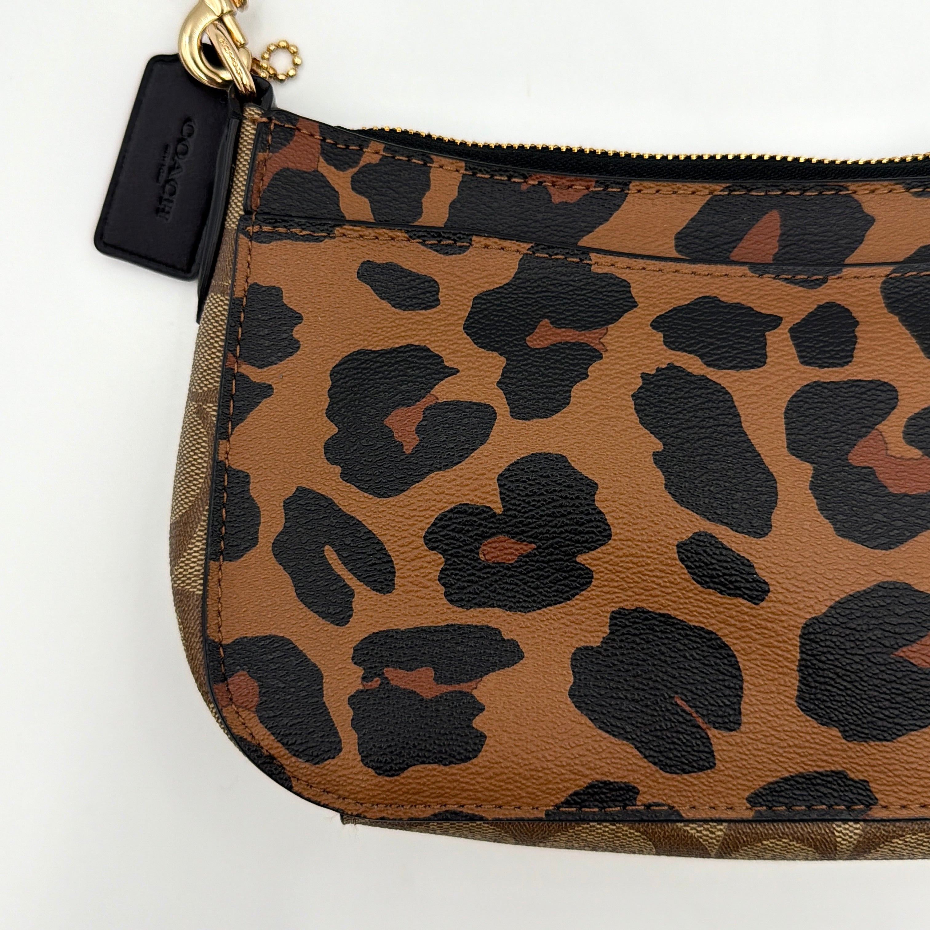 Coach Georgie Shoulder Bag in brown and black leopard print with gold horse and carriage medallion, displayed with its detachable chain and leather strap.