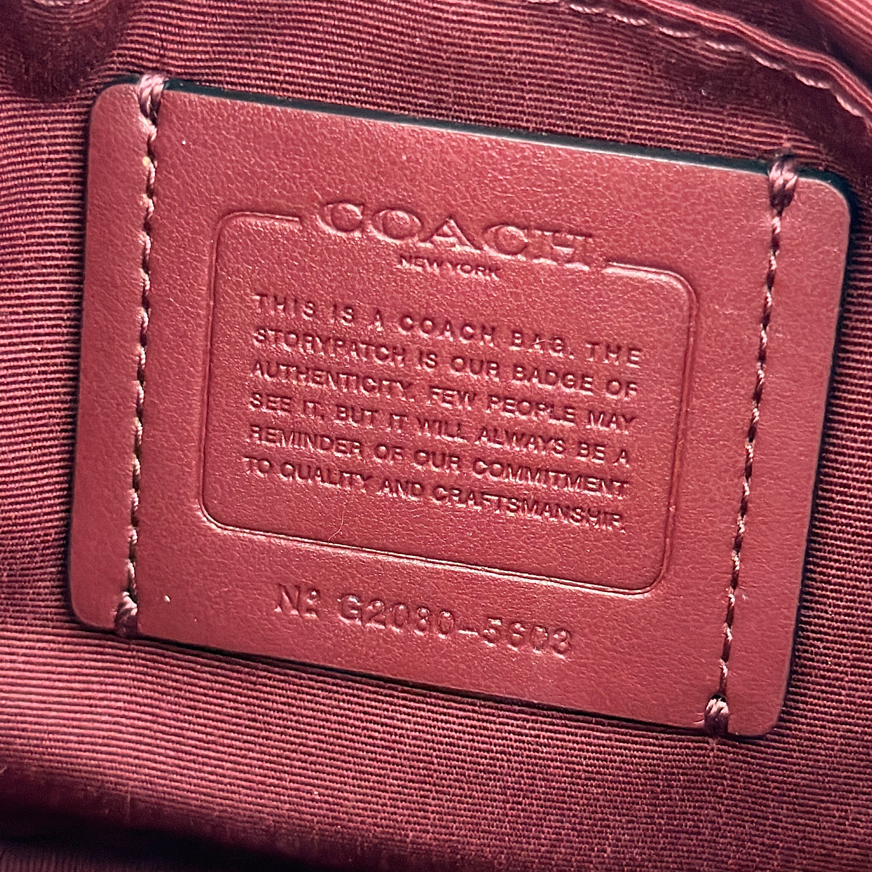 Coach Georgie Shoulder Bag in brown and black leopard print with gold horse and carriage medallion, displayed with its detachable chain and leather strap.