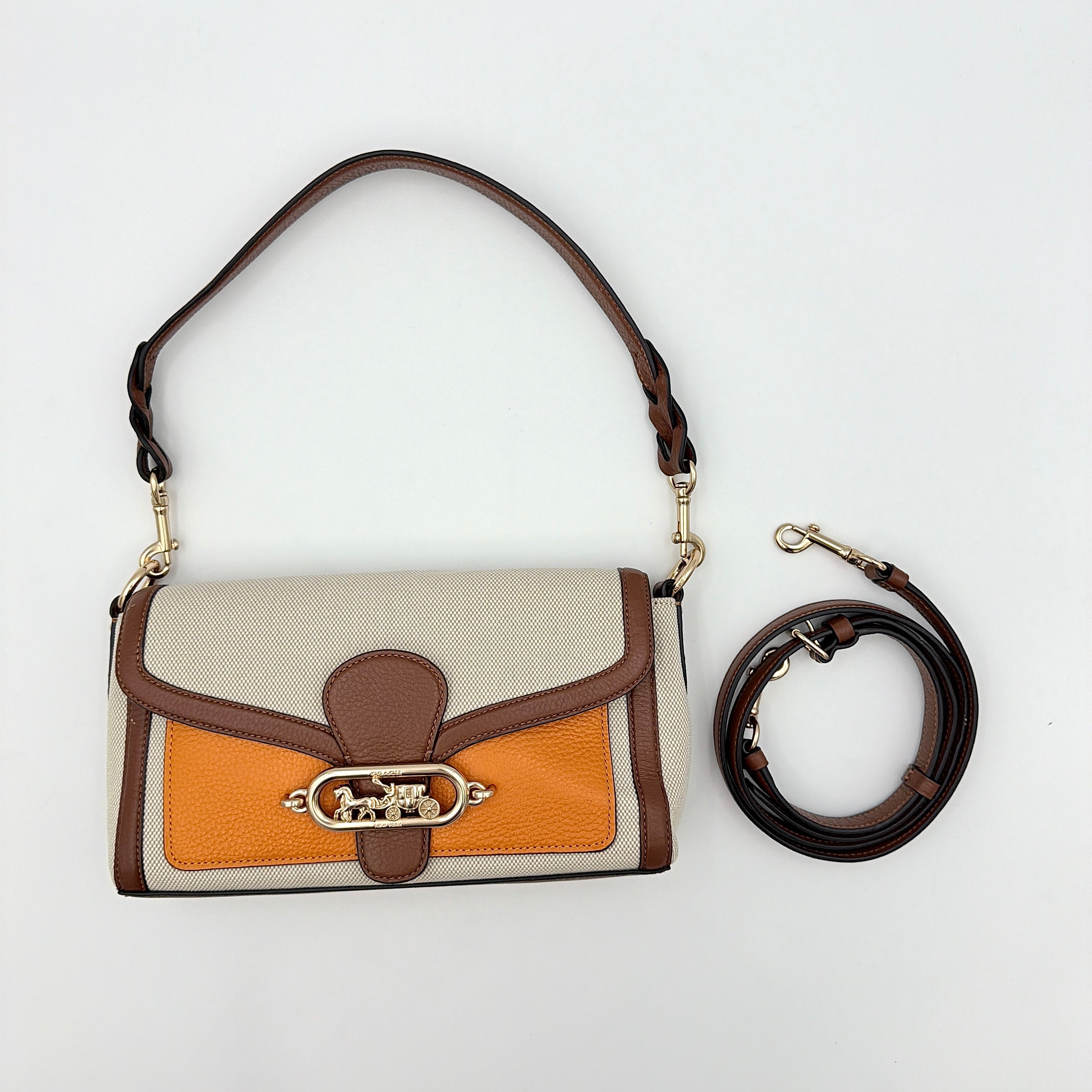 Coach Jade 2Way Shoulder Bag in sand canvas with amber and brown leather trim, gold-tone carriage hardware, and detachable strap.