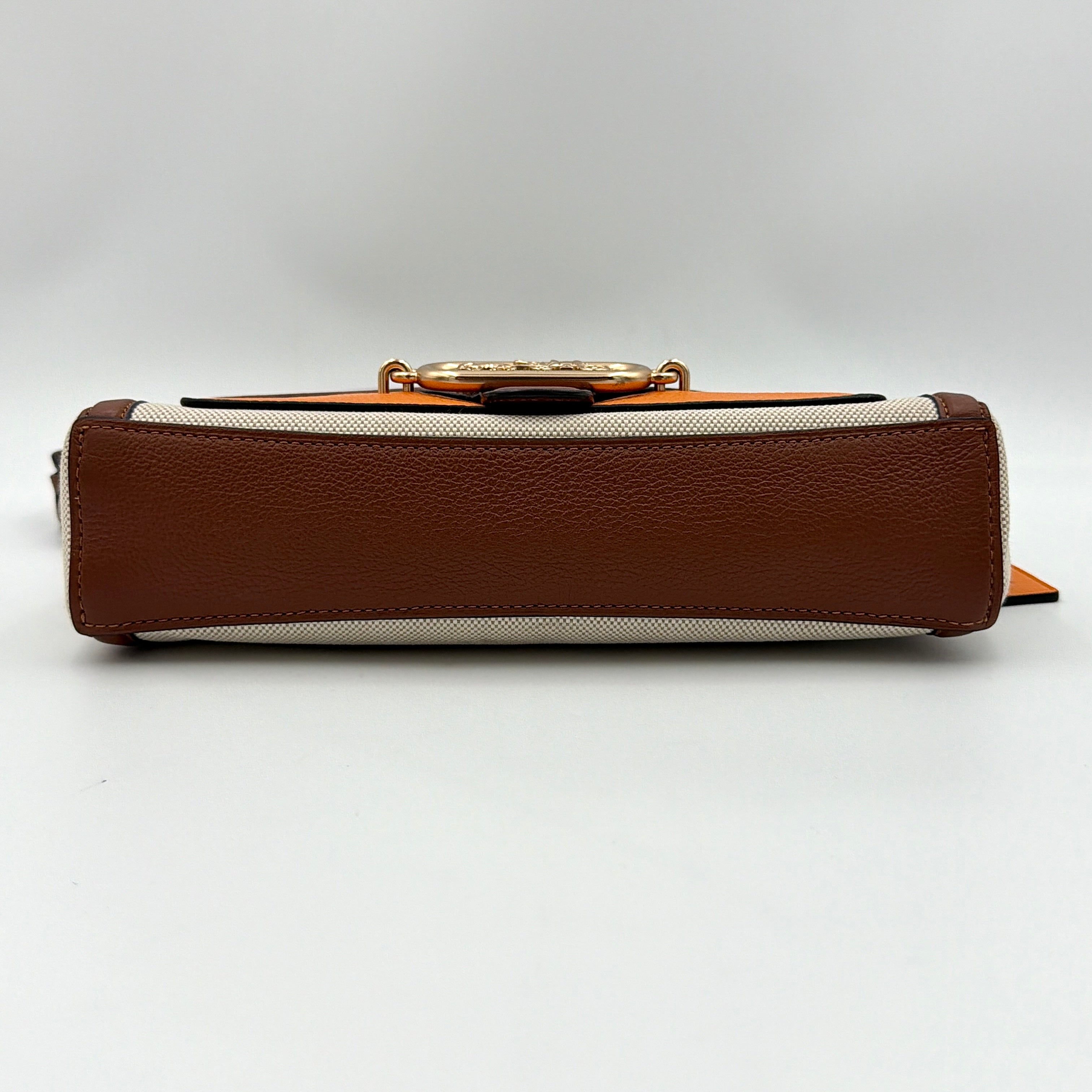 Coach Jade 2Way Shoulder Bag in sand canvas with amber and brown leather trim, gold-tone carriage hardware, and detachable strap.