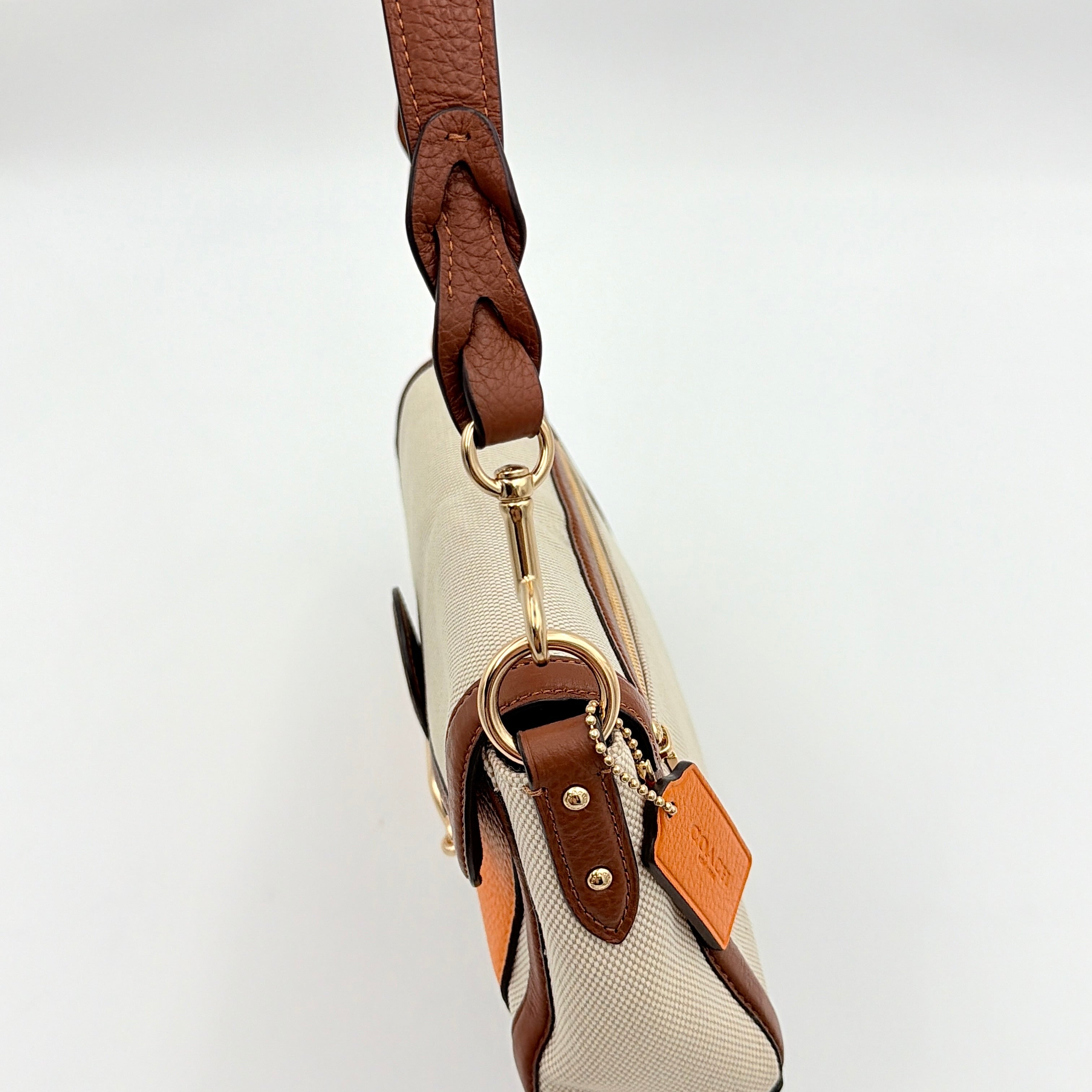 Coach Jade 2Way Shoulder Bag in sand canvas with amber and brown leather trim, gold-tone carriage hardware, and detachable strap.