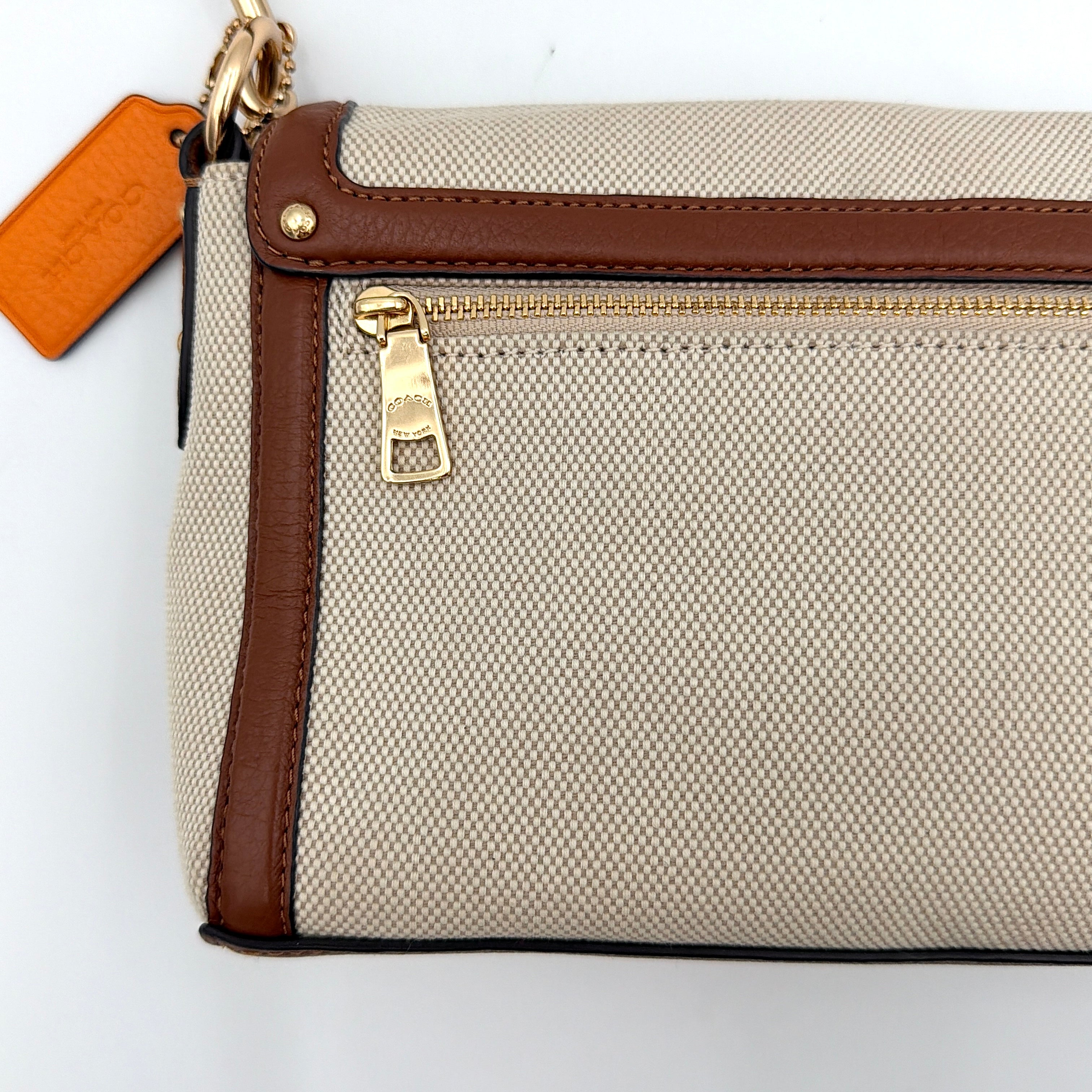 Coach Jade 2Way Shoulder Bag in sand canvas with amber and brown leather trim, gold-tone carriage hardware, and detachable strap.