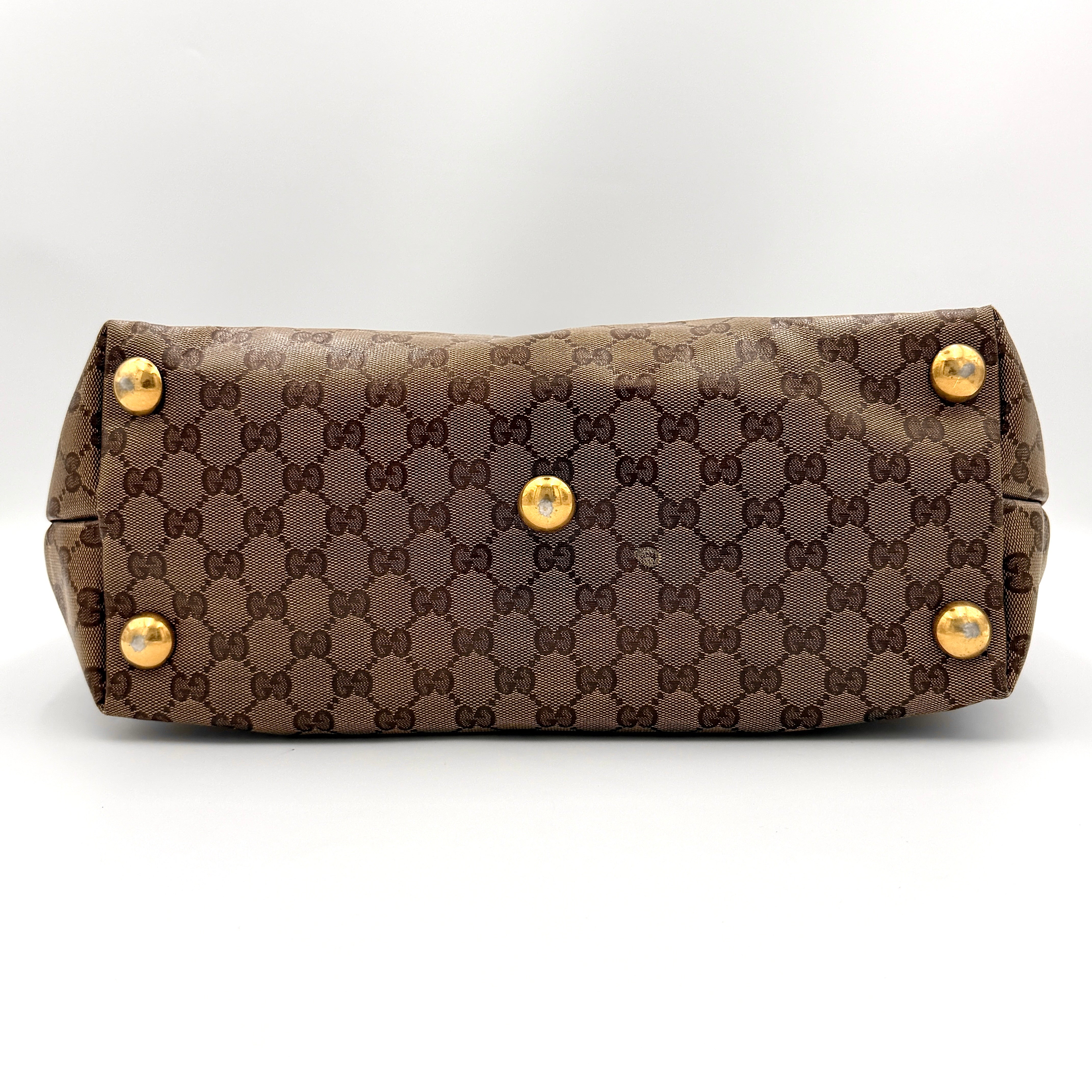 Gucci Babouska shoulder bag in GG monogram crystal canvas with gold-tone stud details and brown leather trim.