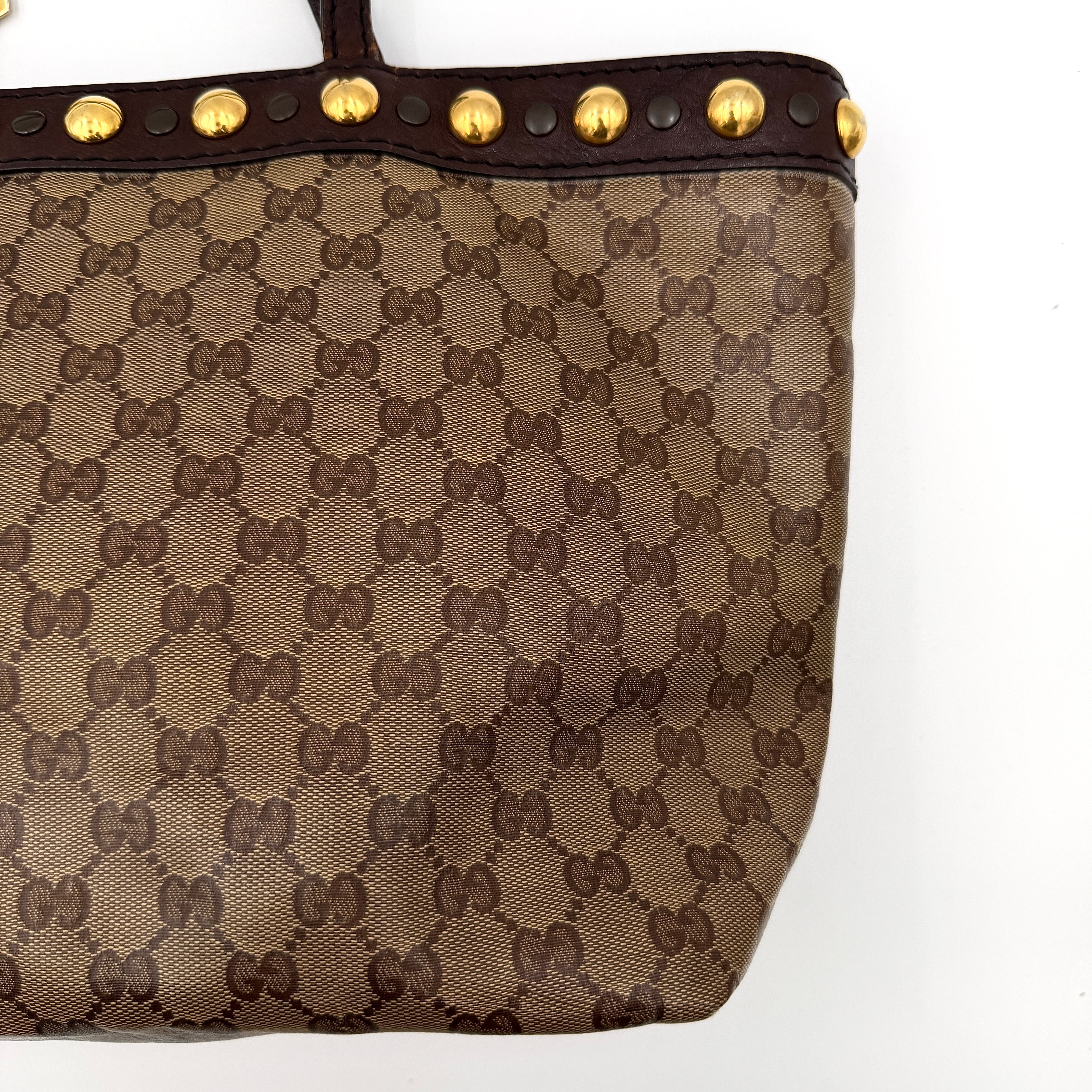 Gucci Babouska shoulder bag in GG monogram crystal canvas with gold-tone stud details and brown leather trim.